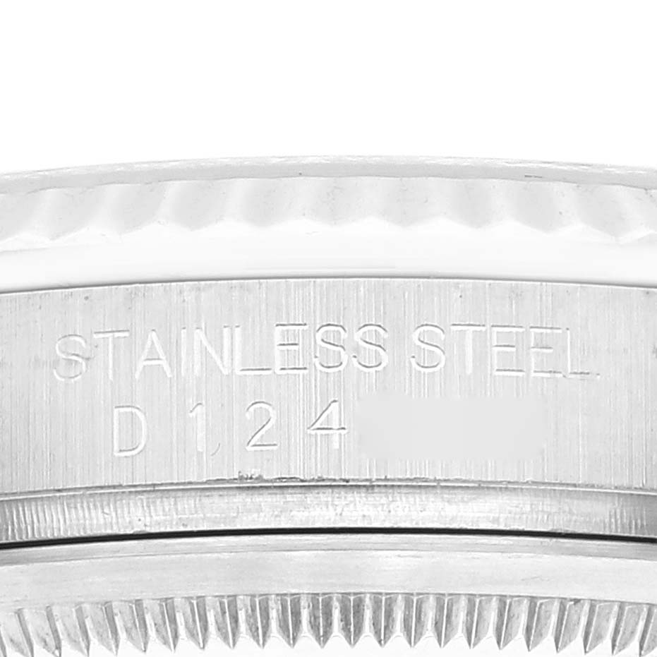 This image shows a close-up of the side of a Rolex Datejust 116234 Men's Stainless Steel Black Dial 116234 Men's Stainless Steel Black Dial watch, focusing on its stainless steel bezel and serial number.