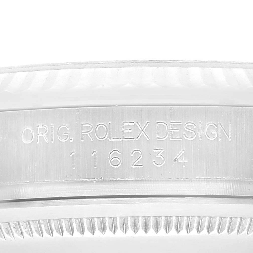 The image shows a close-up of the side of a Rolex Datejust 116234 Men's Stainless Steel Black Dial 116234 Men's Stainless Steel Black Dial watch, specifically the engraved model number and the "Orig. Rolex Design" inscription.
