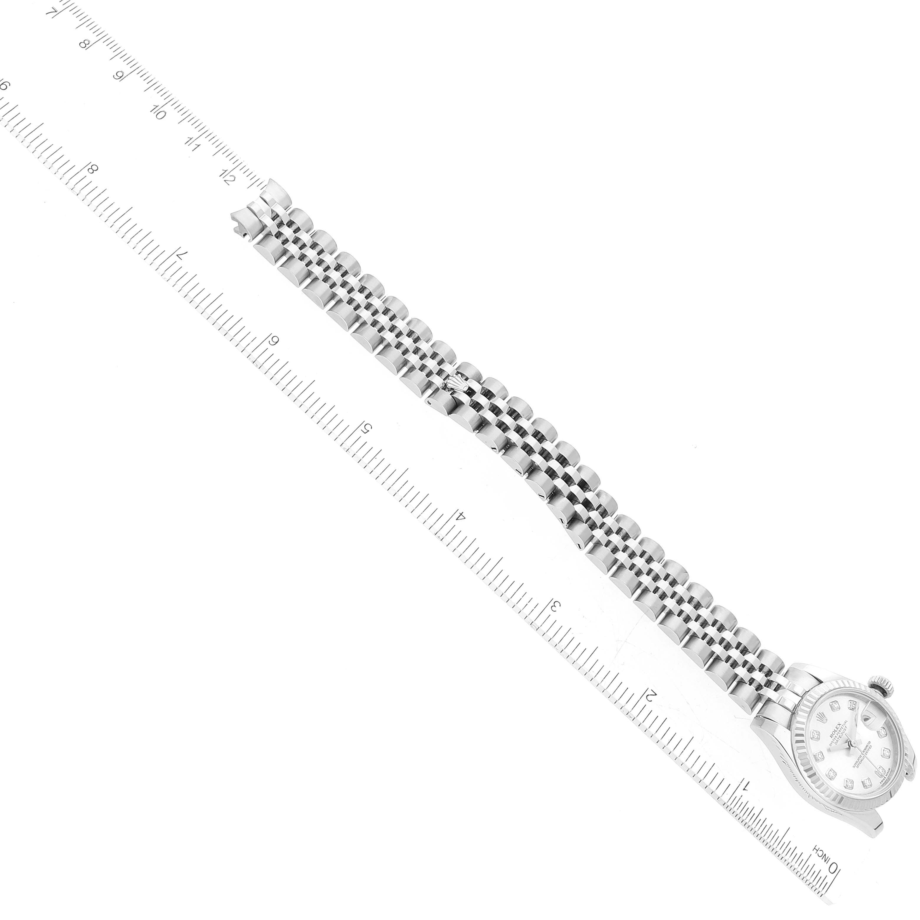 The image shows a top-down view of a Rolex Datejust 179174 Women's Stainless Steel Silver Dial 179174 Women's Stainless Steel Silver Dial model watch with its strap aligned next to a ruler for measurement.