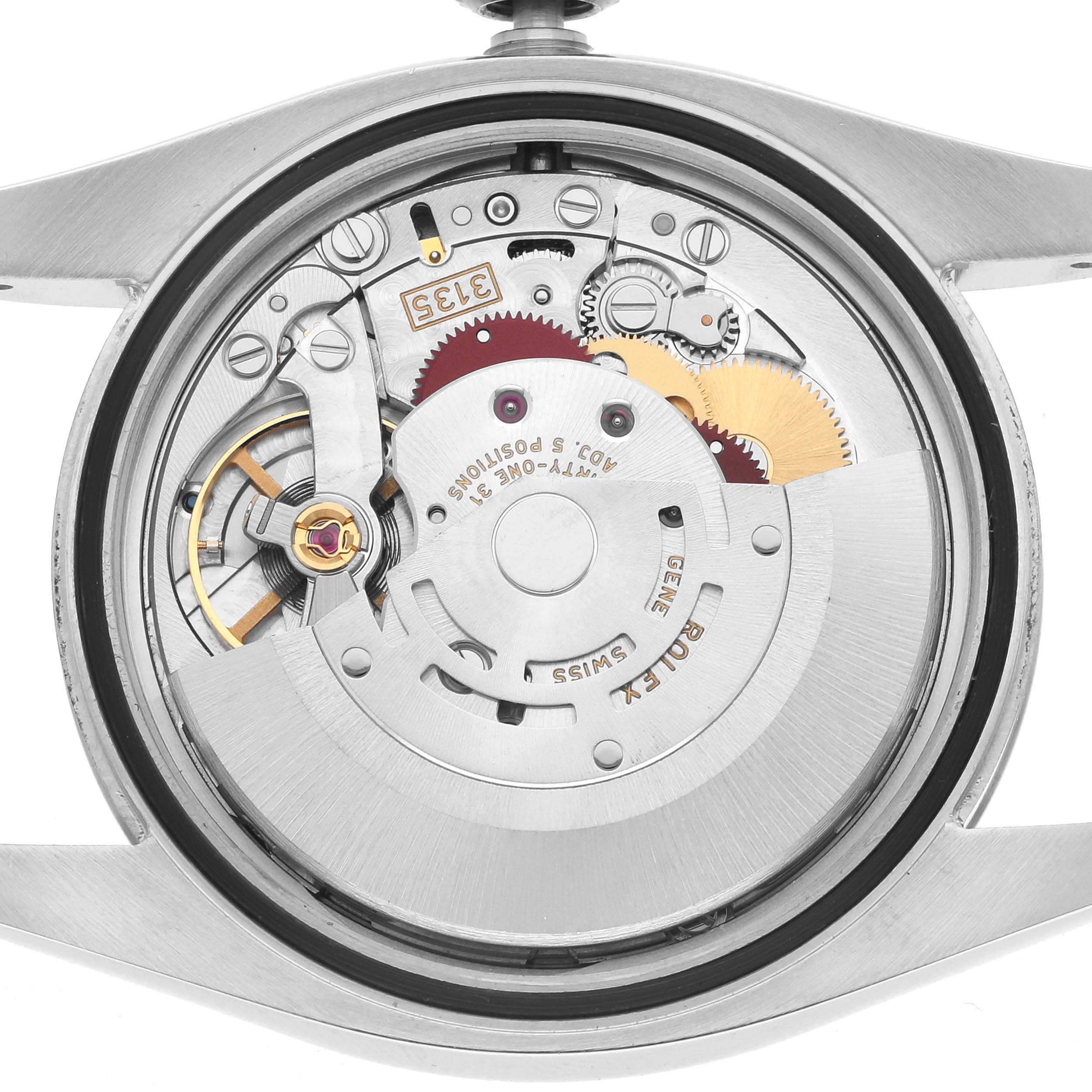 The image shows the movement from the back of the Rolex Datejust 116234 Men
s Stainless Steel Silver Dial watch, highlighting its internal mechanical components.