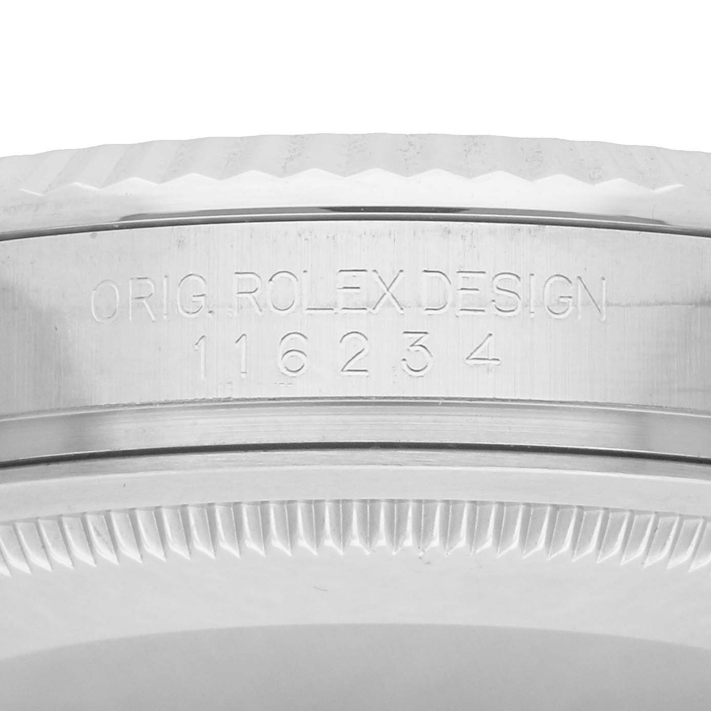 The image shows a close-up of the engraved side and bezel of a Rolex Datejust 116234 Men
s Stainless Steel Silver Dial watch, focusing on the design markings.