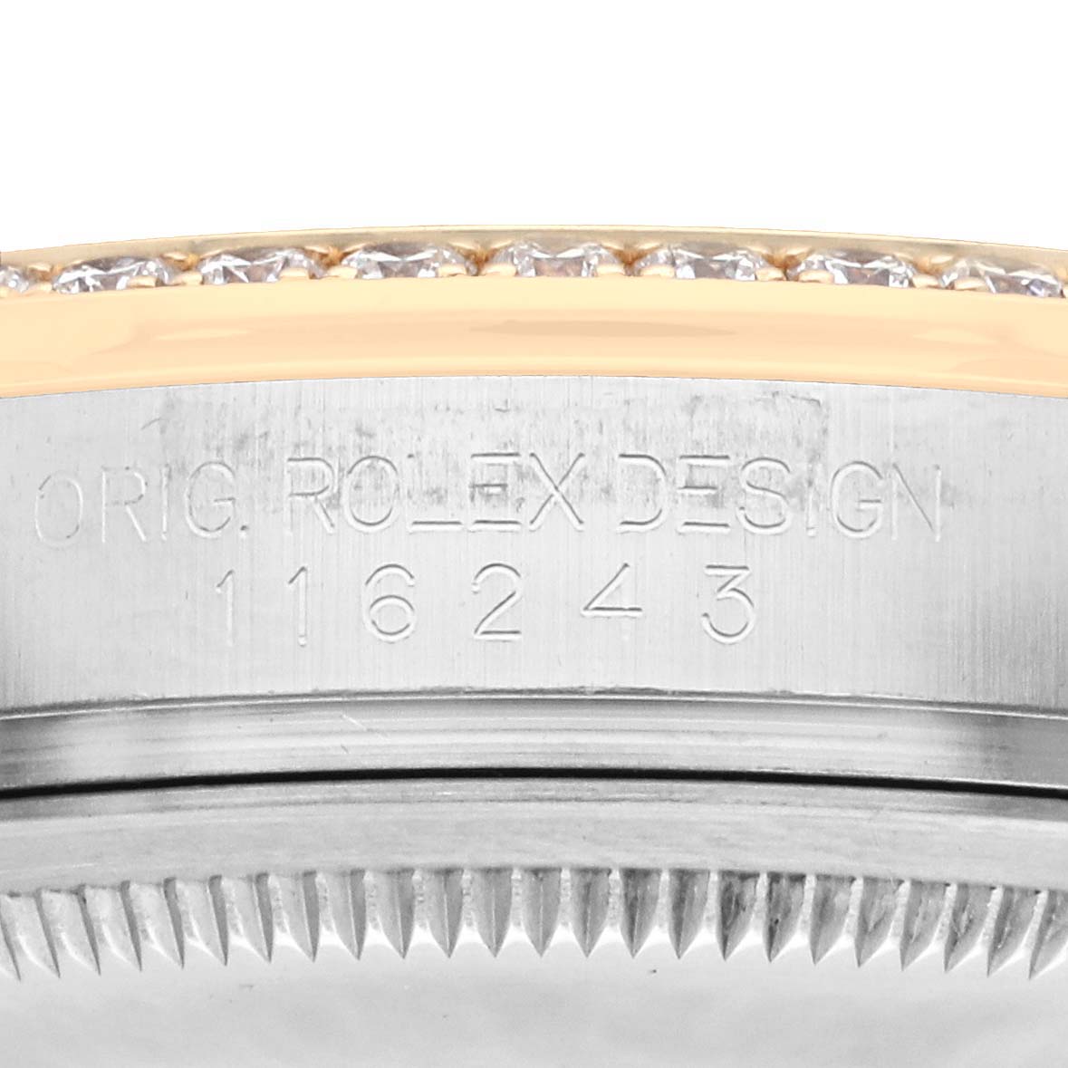 The image shows a close-up of the side of a Rolex Datejust 116243 Men
s Steel and Gold (two tone) Black Dial watch case, highlighting the engraved design number and diamond-set bezel edge.