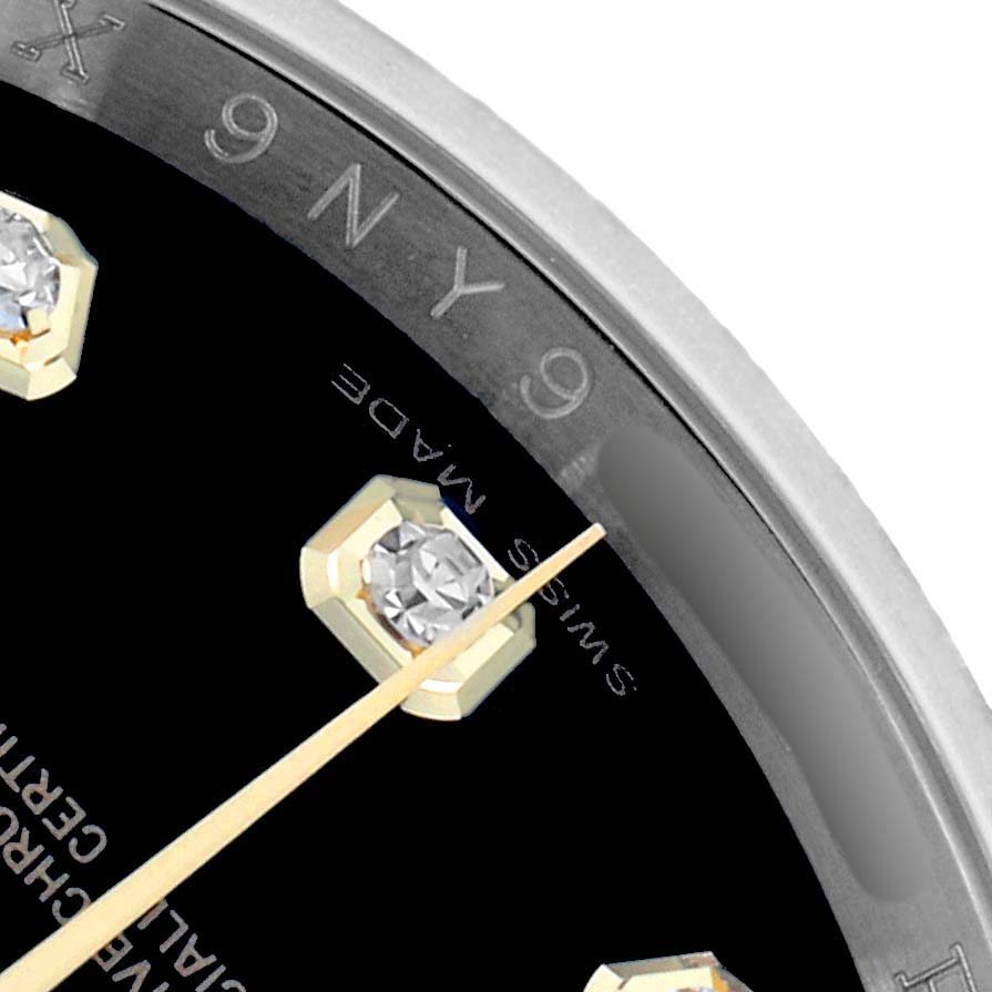 The image shows a close-up of a Rolex Datejust 116243 Men
s Steel and Gold (two tone) Black Dial watch dial, focusing on a diamond hour marker and “Swiss Made” text.