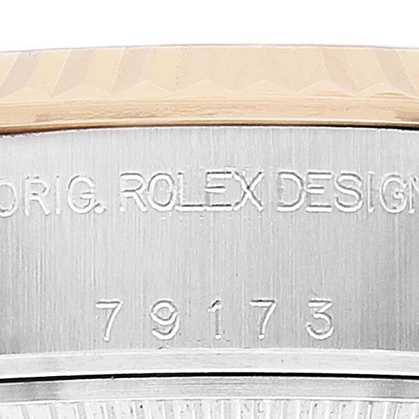 Close-up of the Rolex Datejust 79173 Women's Steel and Gold (two tone) Champagne Dial 79173 Women's Steel and Gold (two tone) Champagne Dial model showing the case edge with engraved details and part of the bezel.