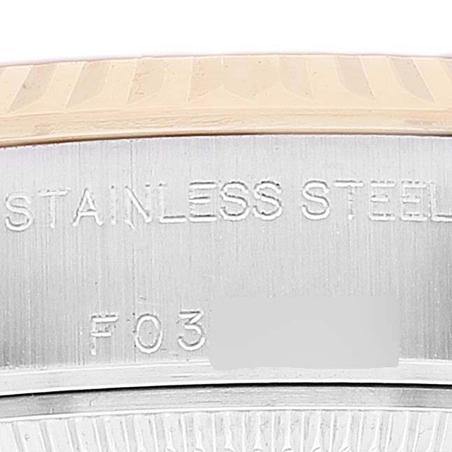 Close-up of the side view showing the engraved stainless steel case and partial fluted bezel of the Rolex Datejust 79173 Women's Steel and Gold (two tone) Champagne Dial 79173 Women's Steel and Gold (two tone) Champagne Dial watch.