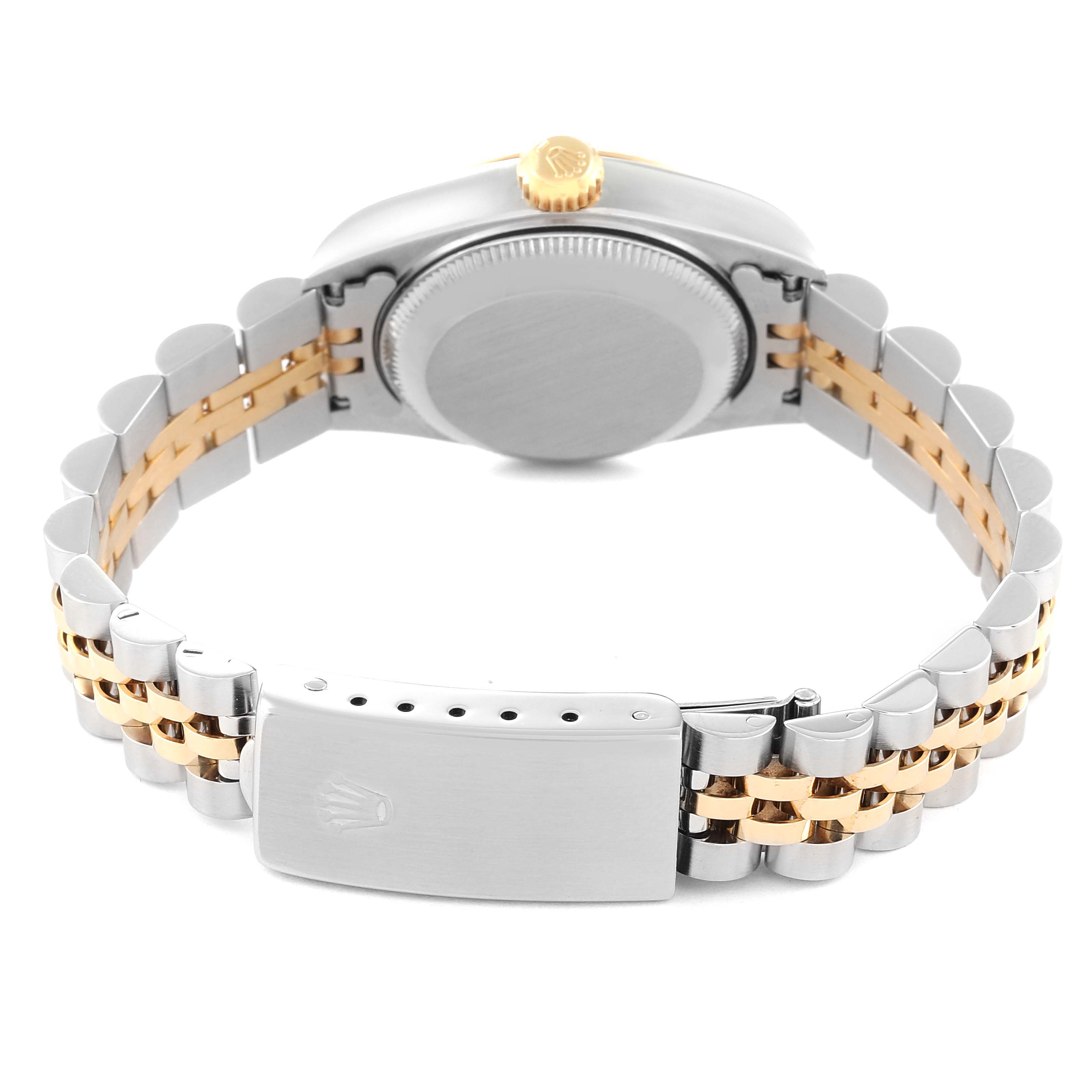 This Rolex Datejust 69173 Women's Stainless Steel Champagne Dial 69173 Women's Stainless Steel Champagne Dial watch is shown from the back, highlighting its case, gold winding crown, and two-tone Jubilee bracelet with the clasp.