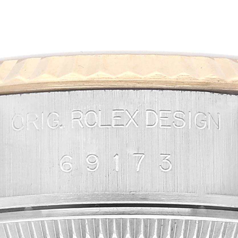 This image shows a close-up of the case side of a Rolex Datejust 69173 Women's Stainless Steel Champagne Dial 69173 Women's Stainless Steel Champagne Dial, featuring the design engraving and model number 69173.