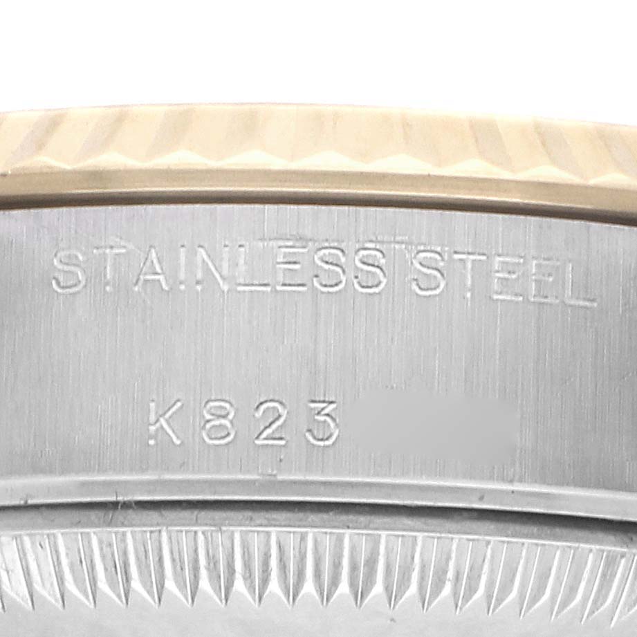 The image shows a close-up of a Rolex Datejust 79173 Women
s Steel and Gold (two tone) Champagne Dial watch case back, highlighting the "STAINLESS STEEL" engraving.