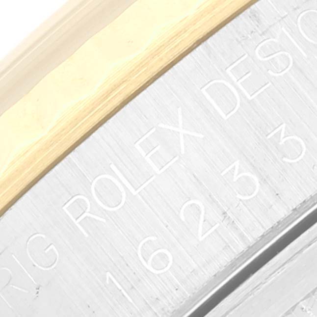This close-up shot of a Rolex Datejust 16233 Men's Steel and Gold (two tone) Champagne Dial 16233 Men's Steel and Gold (two tone) Champagne Dial shows part of the bezel and an engraving on the case side.