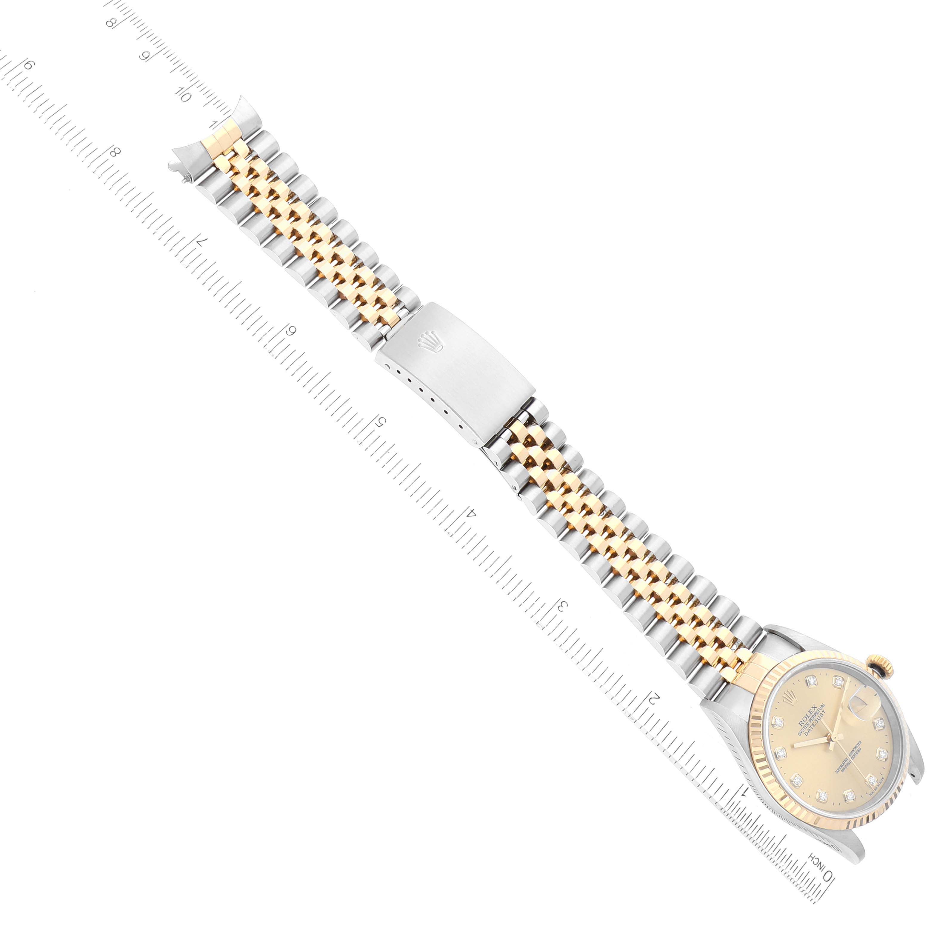The image shows a Rolex Datejust 16233 Men's Steel and Gold (two tone) Champagne Dial 16233 Men's Steel and Gold (two tone) Champagne Dial model watch laid flat with its gold and silver bracelet fully extended alongside a ruler.