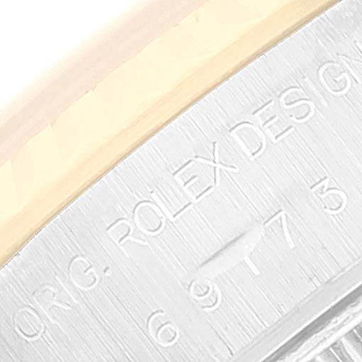This is a close-up image showing the engraving on the case edge of a Rolex Datejust 69173 Women's Steel and Gold (two tone) Champagne Dial 69173 Women's Steel and Gold (two tone) Champagne Dial watch.