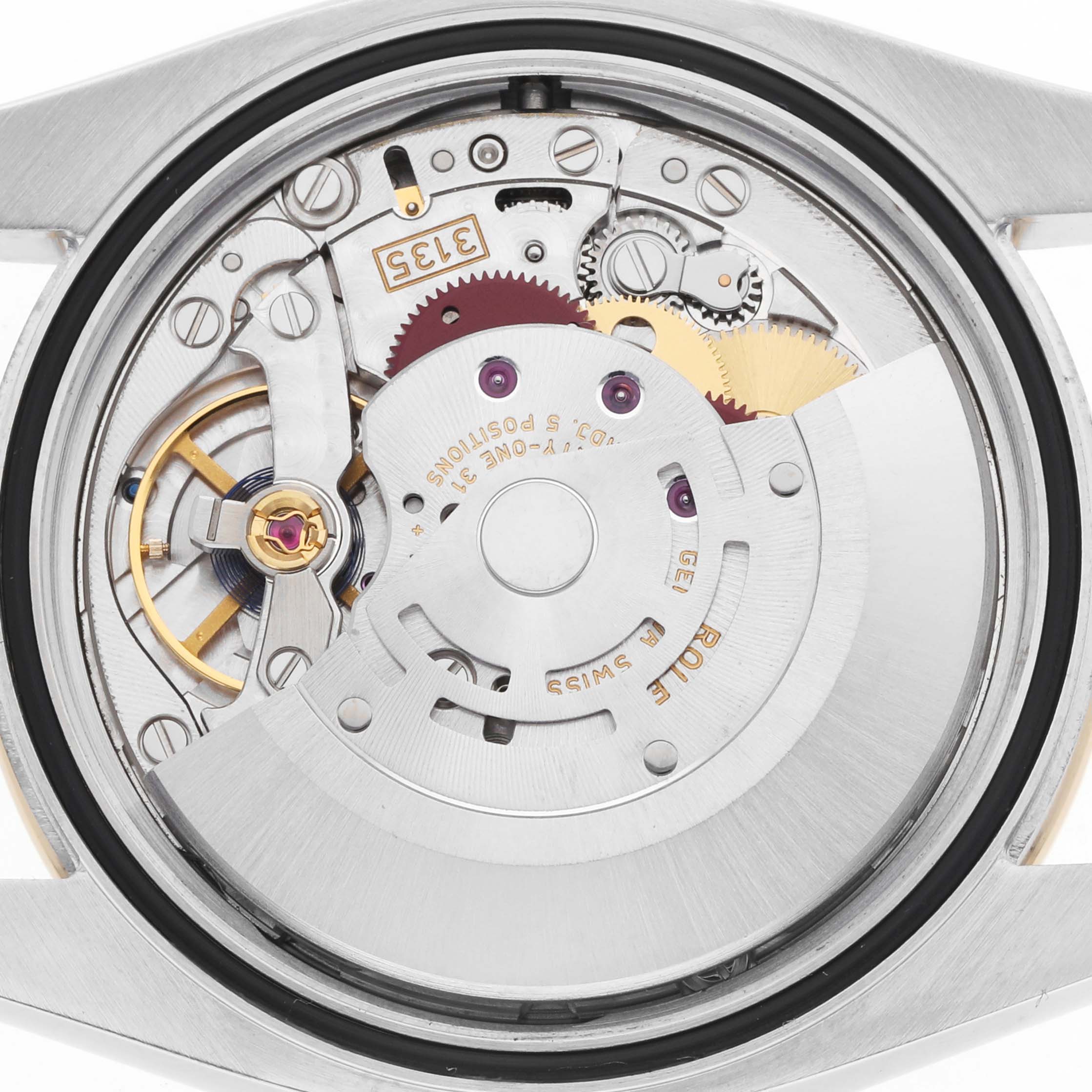 The image shows the movement of a Rolex Datejust 116243 Men
s Steel and Gold (two tone) Silver Dial watch from the back, highlighting gears and mechanisms.