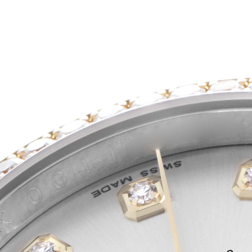 The image shows a close-up of the diamond hour markers and part of the bezel of a Rolex Datejust 116243 Men
s Steel and Gold (two tone) Silver Dial watch.