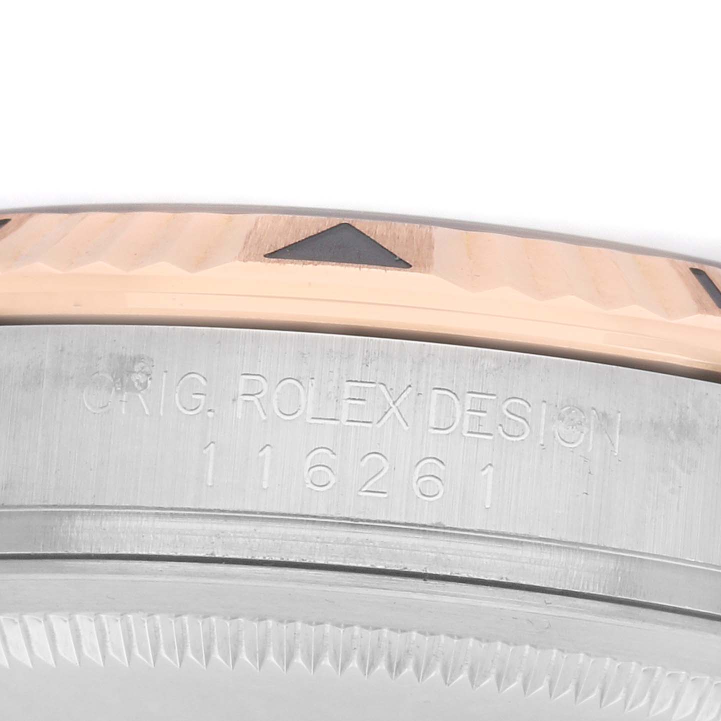 The image shows the side view of a Rolex Turn-o-Graph 116261 Men
s Steel and Gold (two tone) Silver Dial model, focusing on the engraved bezel and model number.