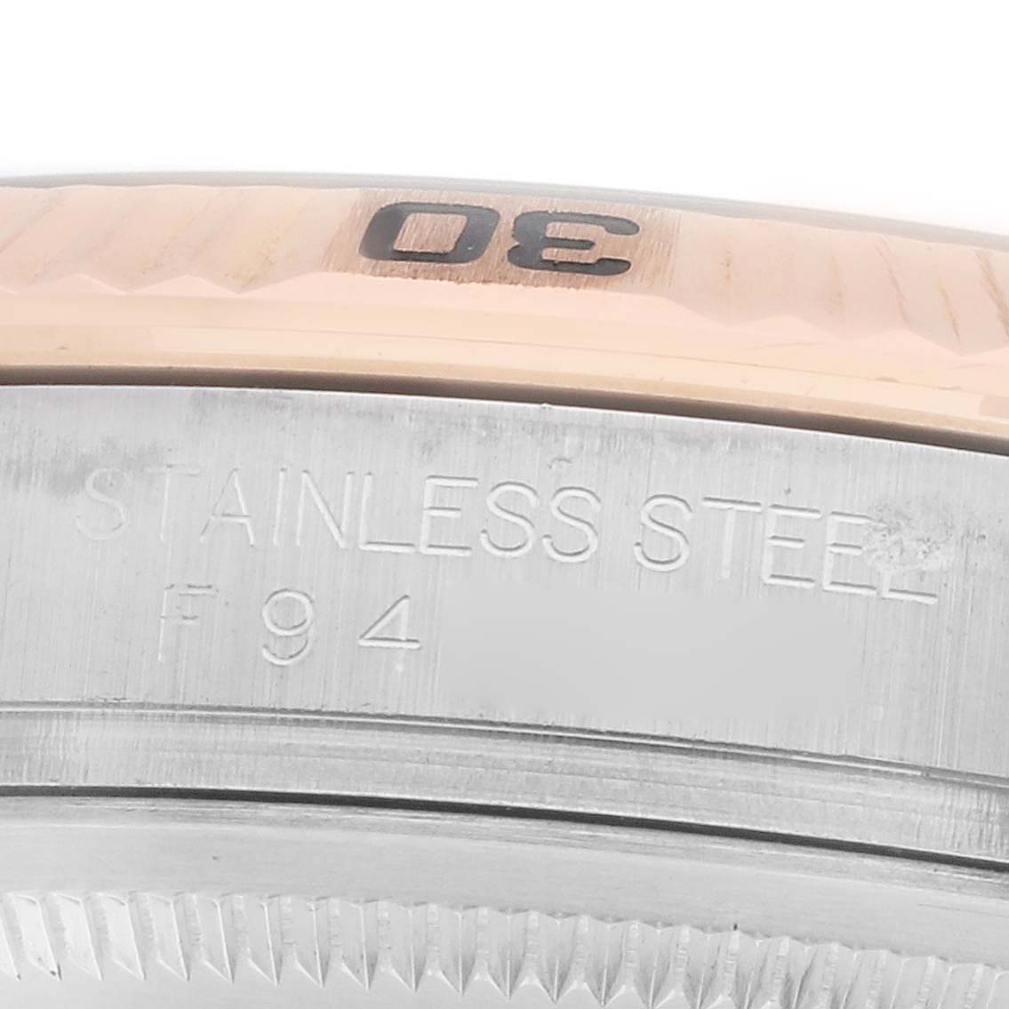 The image shows a close-up of the Turn-o-Graph model by Rolex, focusing on the bezel and engraved markings.