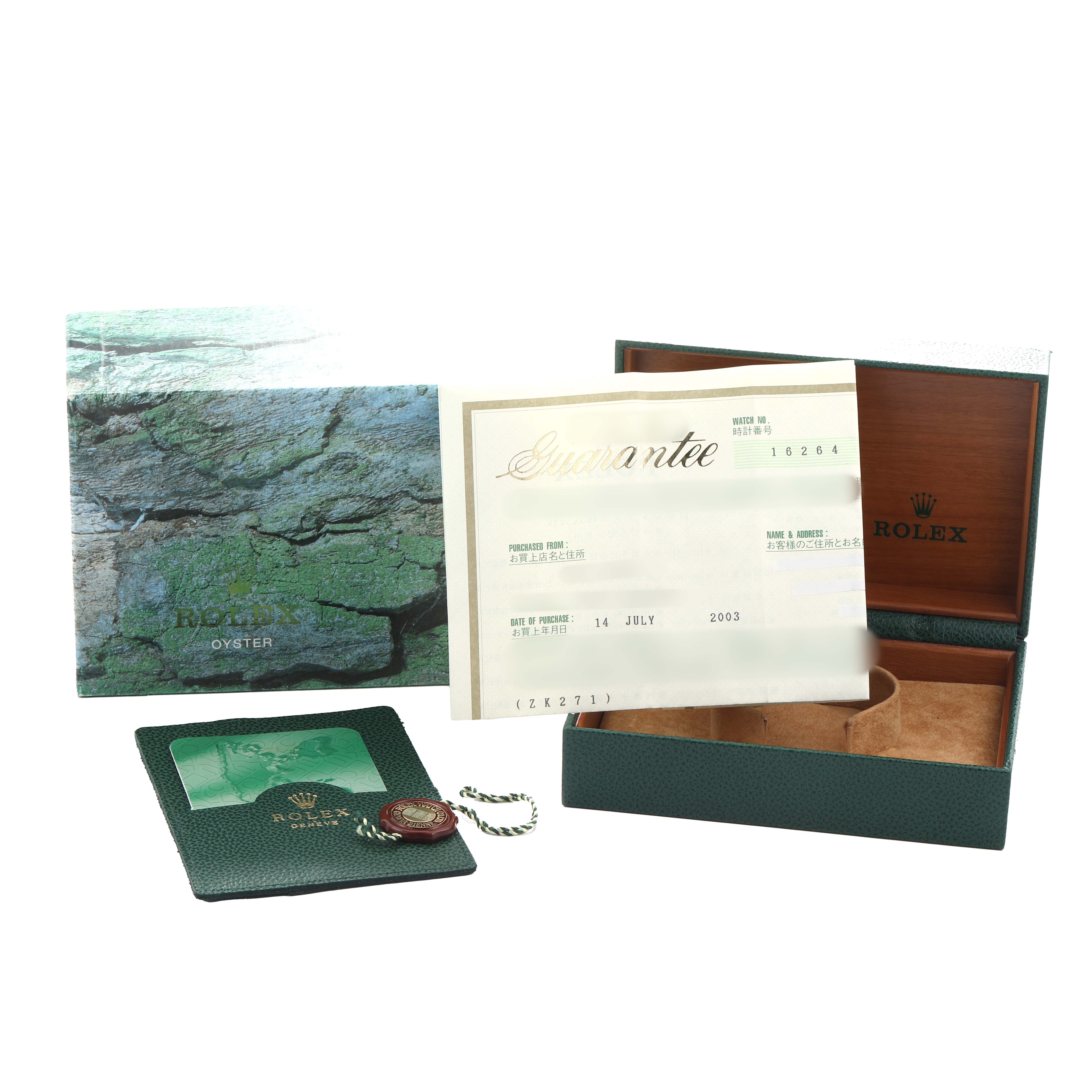 The image shows the accessories for a Rolex Turn-o-Graph 16264 Men
s Stainless Steel Blue Dial, including a box, certificate, and booklet.