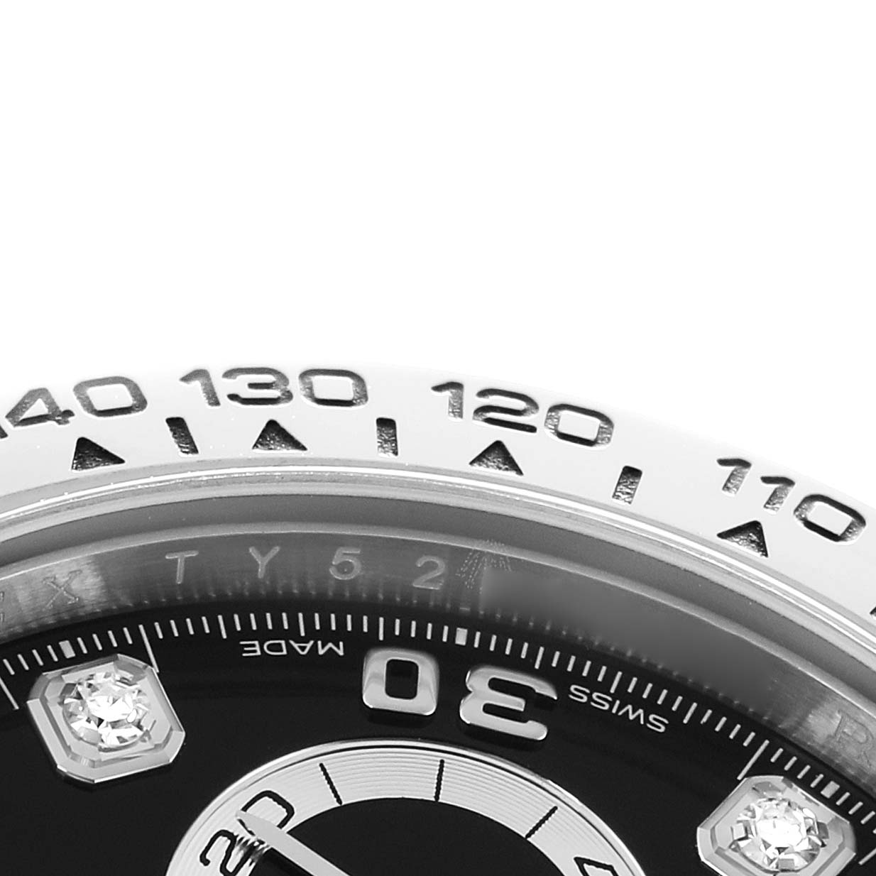 The image shows a close-up of the bezel and partially visible dial of a Rolex Daytona 116509 Men's White Gold Black Dial watch.
