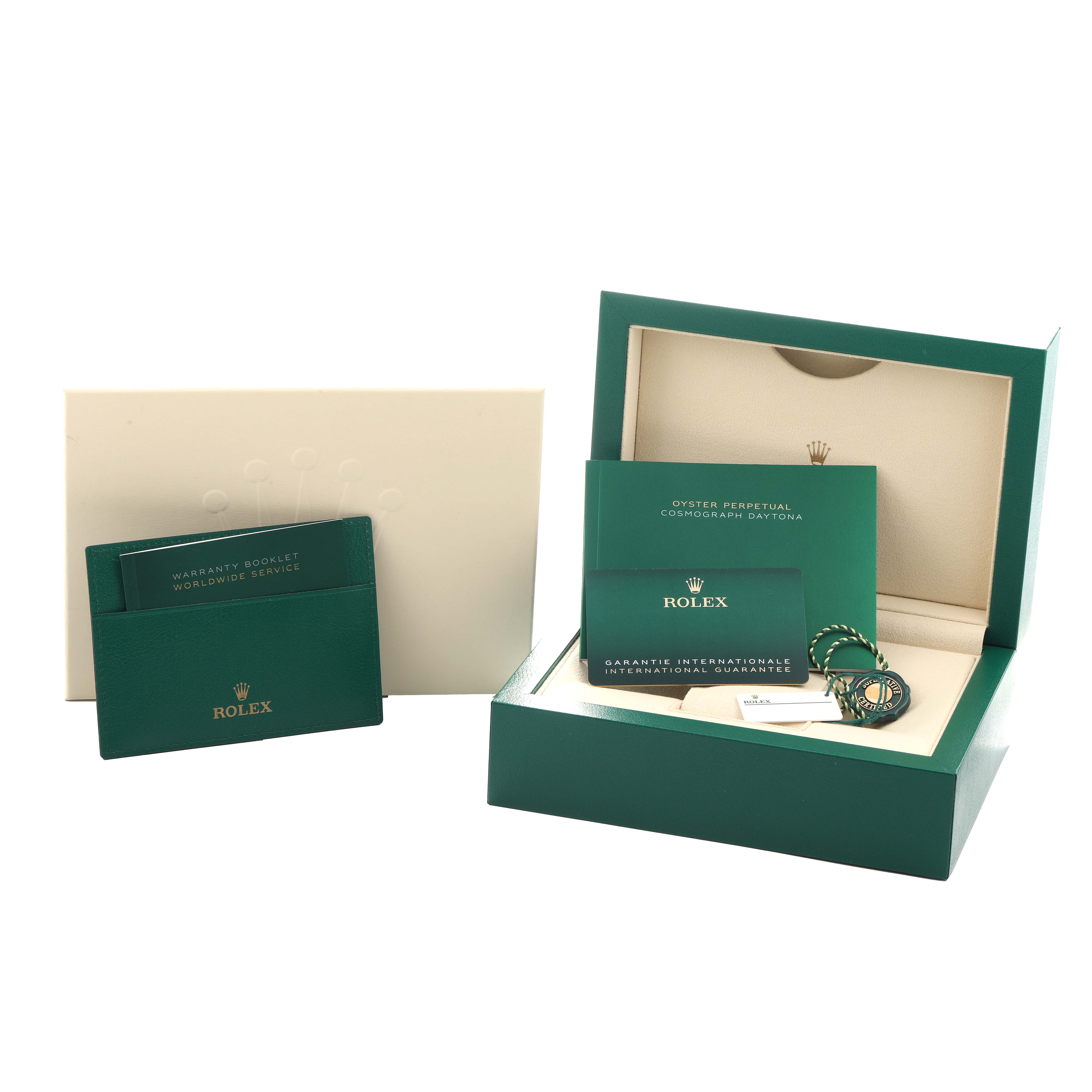 The image shows a Rolex Daytona 116500 Men
s Stainless Steel Black Dial watch box, instruction booklets, warranty card, and tag, viewed from a front angle.