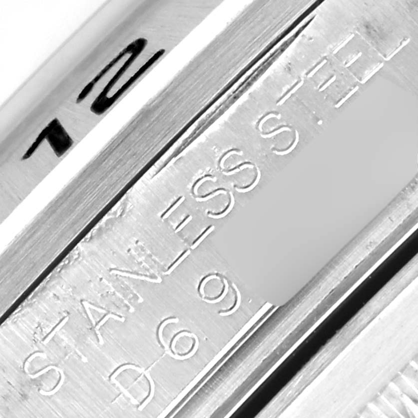 The image shows a close-up of the inner side of the Rolex Explorer 16570 Men
s Stainless Steel Black Dial 16570 Men
s Stainless Steel Black Dial watch case, displaying the "STAINLESS STEEL" engraving.