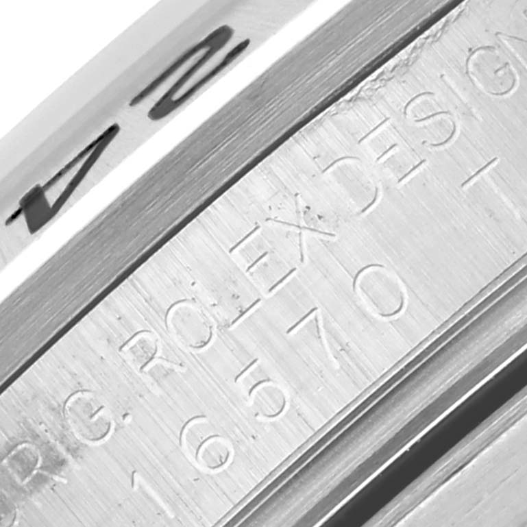 The image shows a close-up of the engraved inner bezel of a Rolex Explorer 16570 Men
s Stainless Steel Black Dial 16570 Men
s Stainless Steel Black Dial watch.
