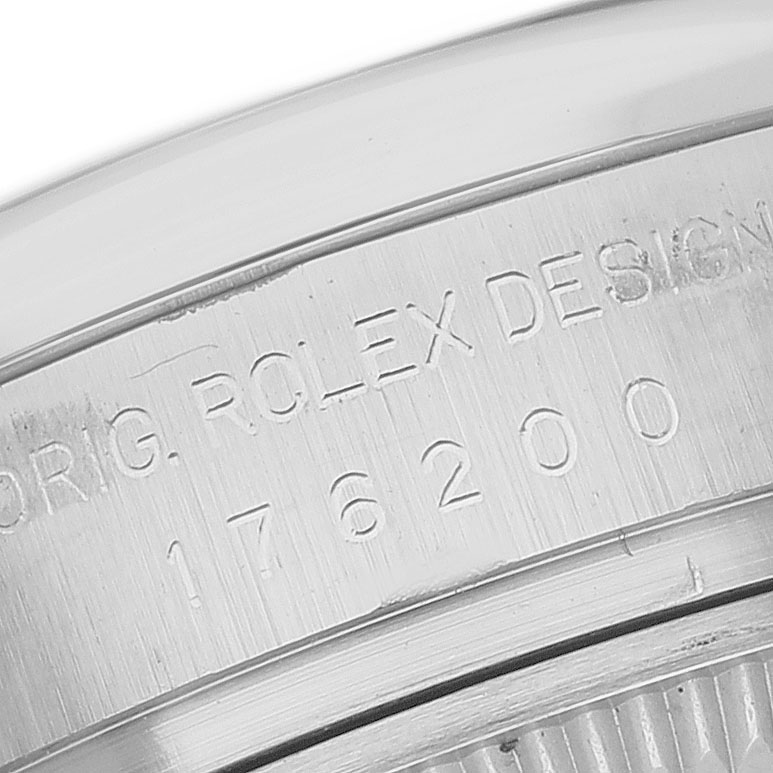 The image shows a close-up of the side engraving on a Rolex Oyster Perpetual 176200 Women's Stainless Steel Silver Dial, displaying part of the serial number.