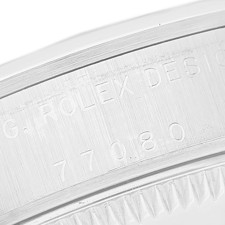 The image shows a close-up of the engraved bezel or case edge of a Mid-Size Rolex watch.