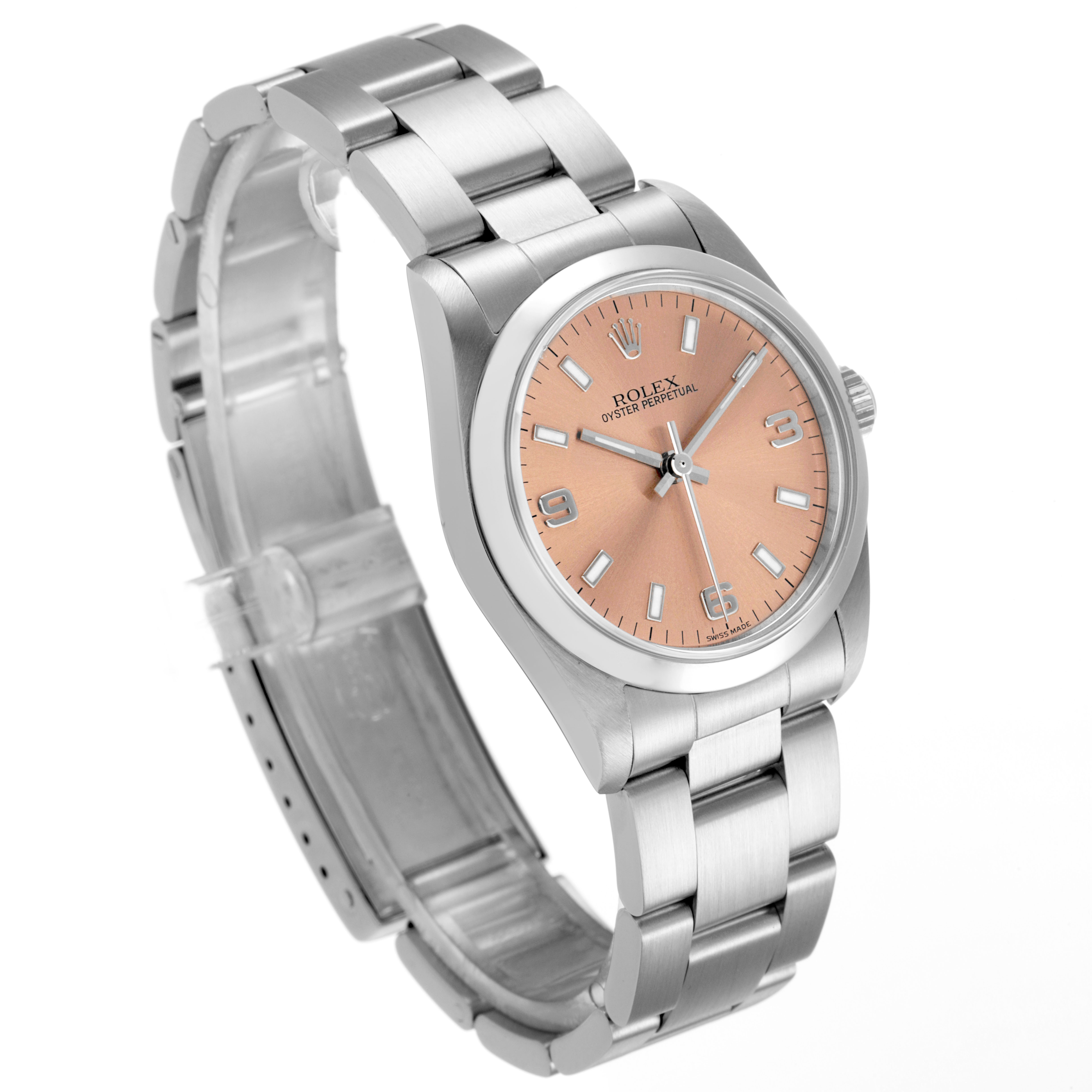 The Rolex Mid-Size 77080 Women's Stainless Steel Pink Dial model is shown at a three-quarter angle, displaying the bracelet, bezel, crown, and salmon-colored dial.
