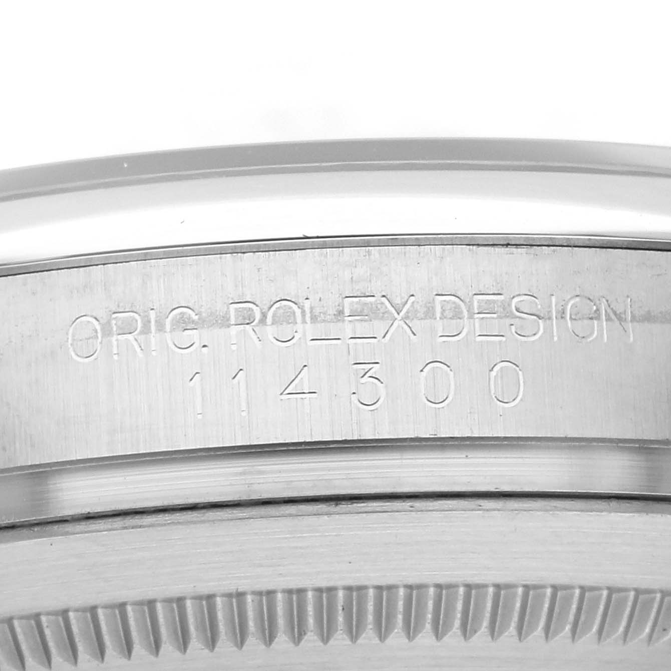 The image shows the side engraving on the casing of a Rolex Oyster Perpetual 114300 Men's Stainless Steel Blue Dial 114300 Men's Stainless Steel Blue Dial, displaying the model number.