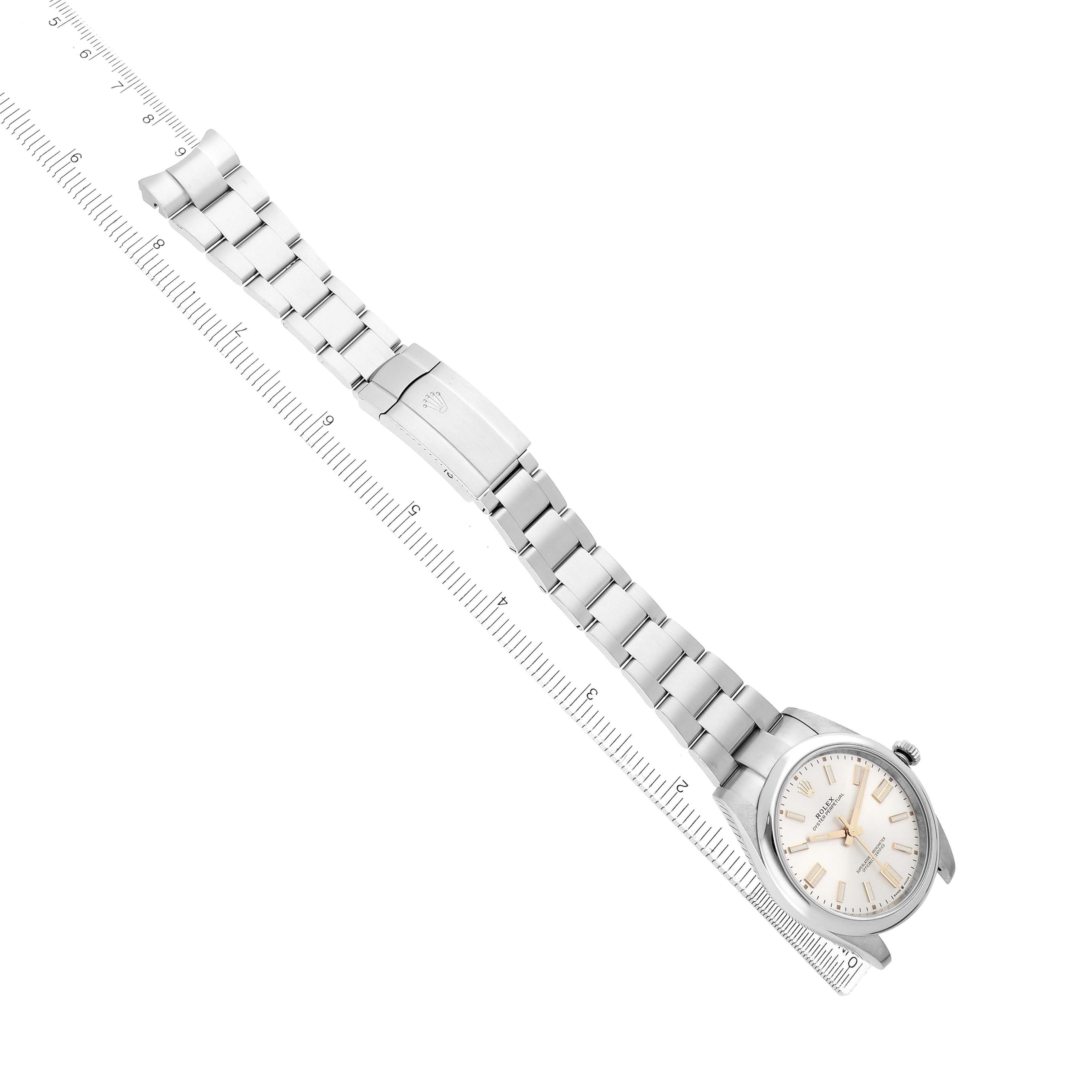 The Rolex Oyster Perpetual 124300 Men
s Stainless Steel Silver Dial watch is shown from a top view, displaying the full bracelet, clasp, and watch face diagonally aligned.