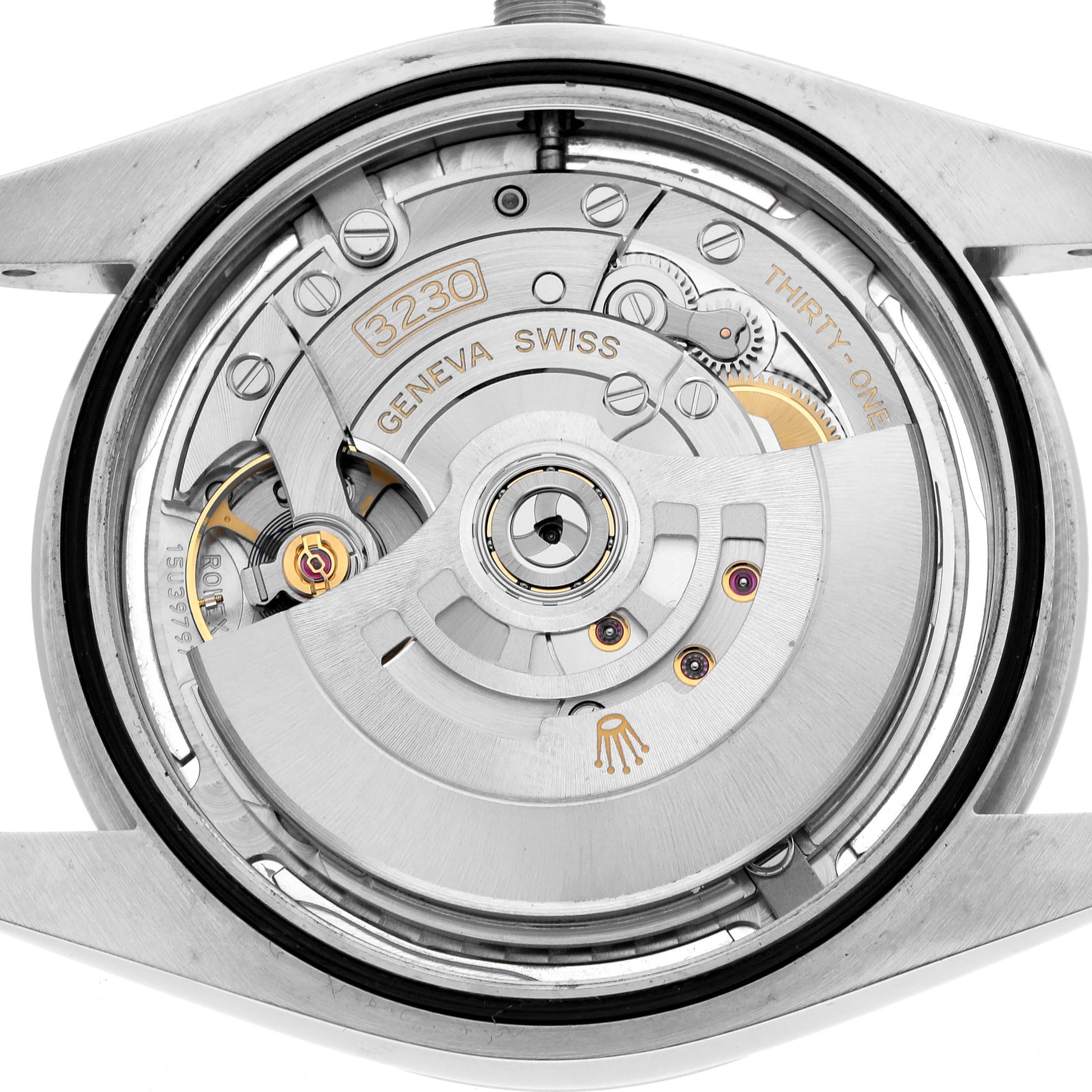 This image shows the back of a Rolex Oyster Perpetual 124300 Men
s Stainless Steel Silver Dial, highlighting its intricate movement and gears.