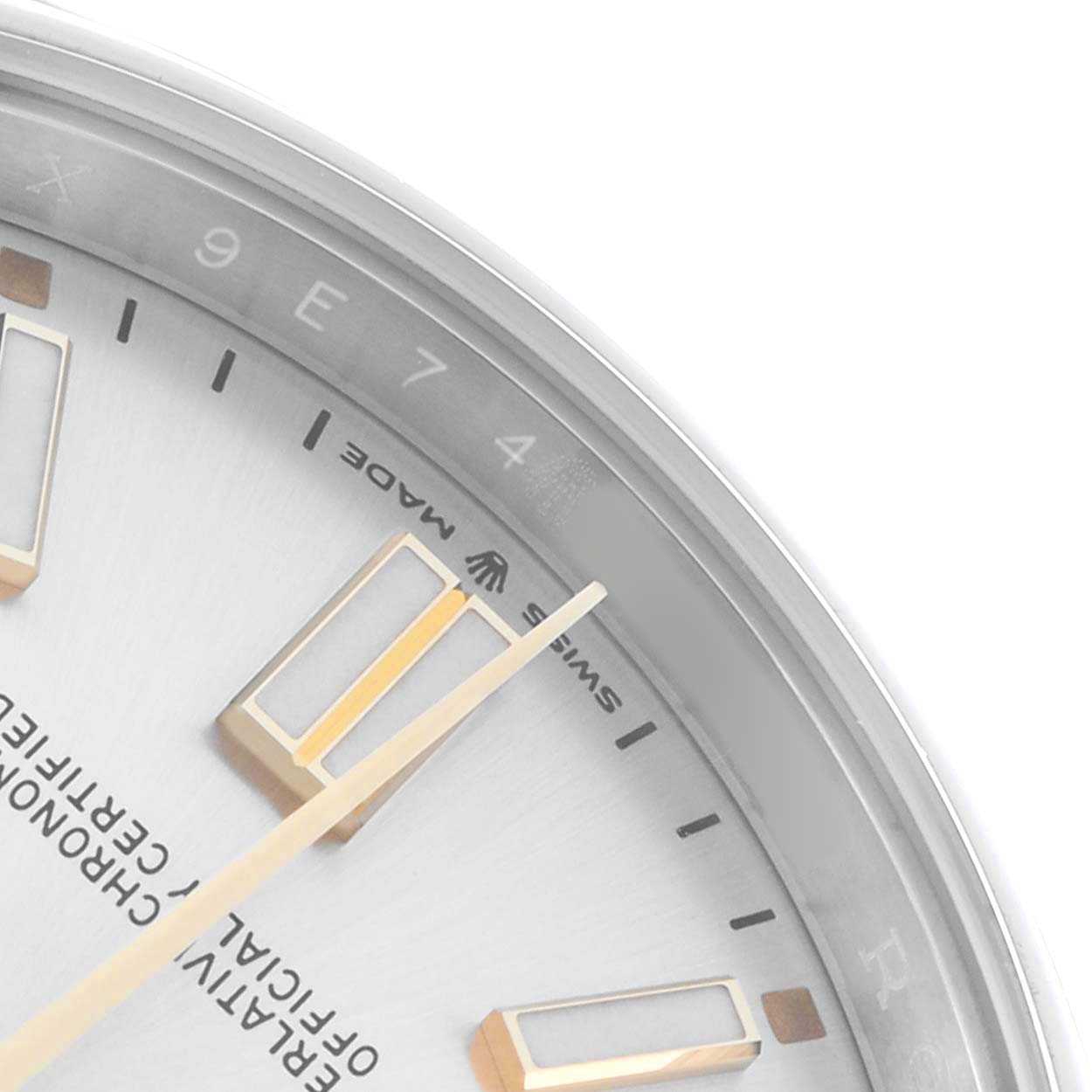 The image shows a close-up of the Rolex Oyster Perpetual 124300 Men
s Stainless Steel Silver Dial watch
s dial, highlighting the hands, markers, and part of the bezel.