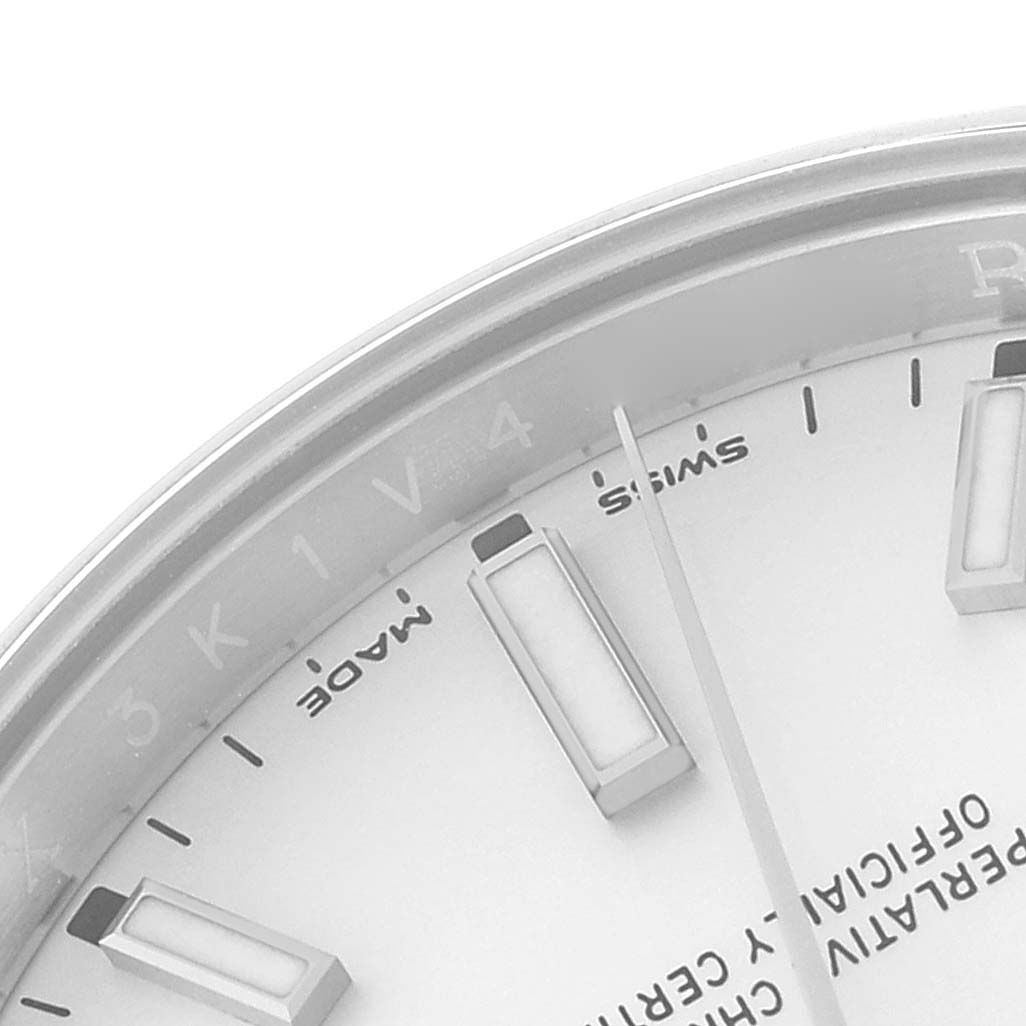 The image shows a close-up of the dial and hands of a Rolex Oyster Perpetual 114200 Men's Stainless Steel White Dial 114200 Men's Stainless Steel White Dial watch, focusing on the 3, 4, and 5 o'clock positions.