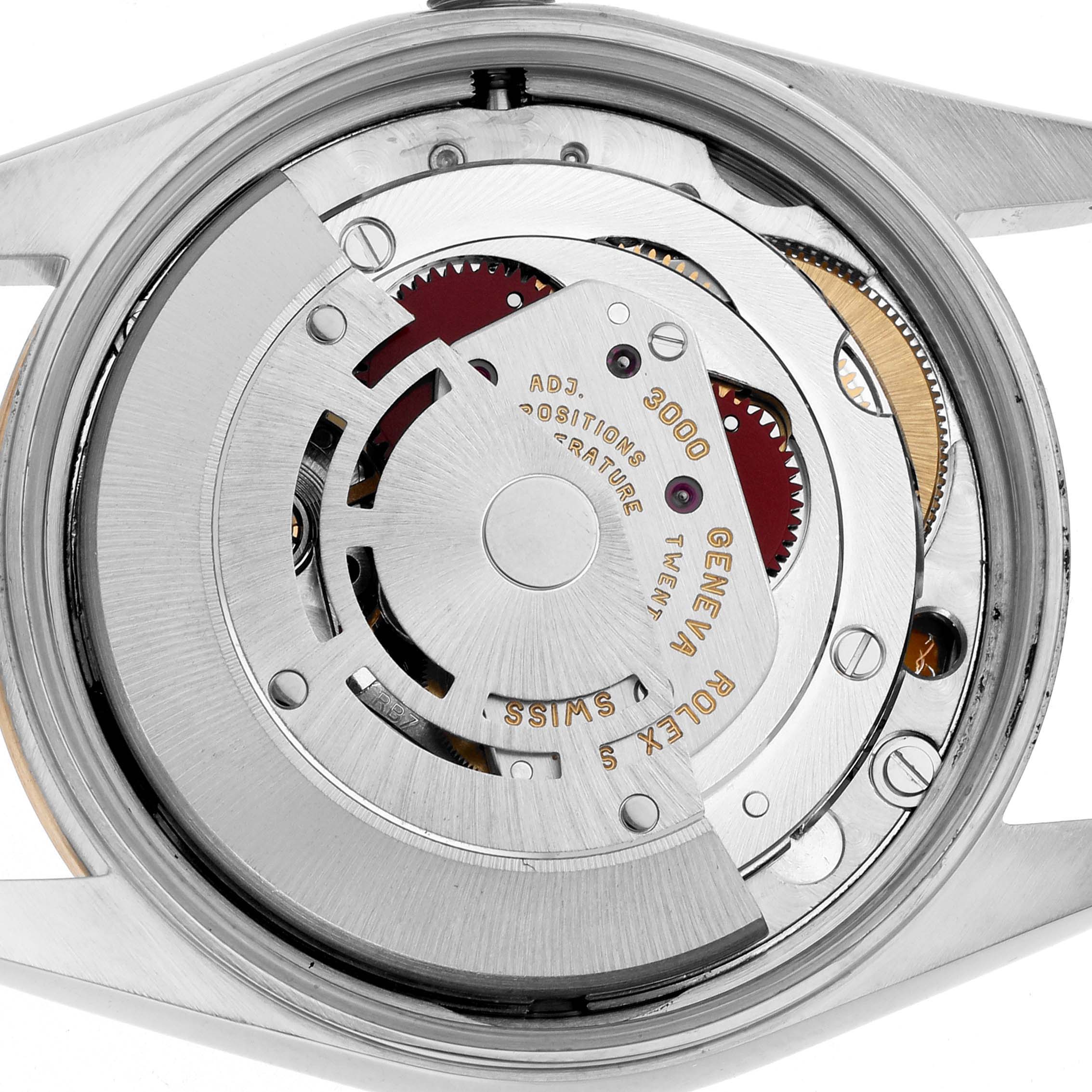 The image shows the movement of a Rolex Oyster Perpetual 14203 Men
s Steel and Gold (two tone) Champagne Dial watch from the back, highlighting its intricate mechanical parts.
