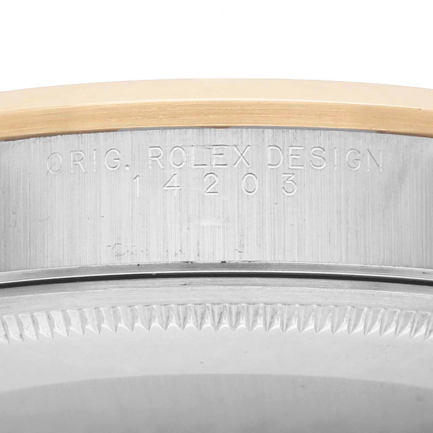 The image shows a close-up side view of a Rolex Oyster Perpetual 14203 Men
s Steel and Gold (two tone) Champagne Dial watch, highlighting the engraved model number and bezel edge.