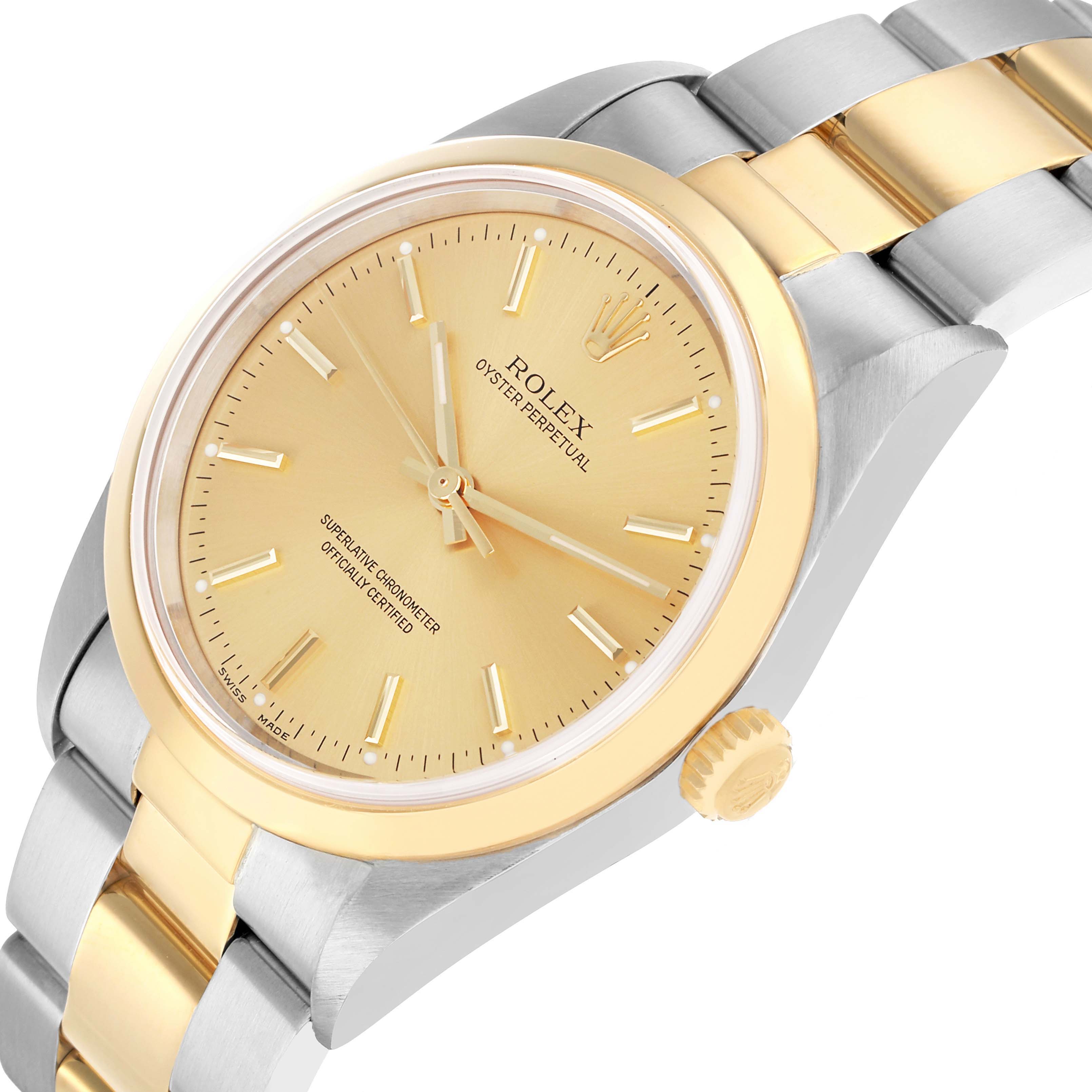The Rolex Oyster Perpetual 14203 Men
s Steel and Gold (two tone) Champagne Dial watch is shown at a slight angle highlighting the face, bezel, crown, and part of the bracelet.