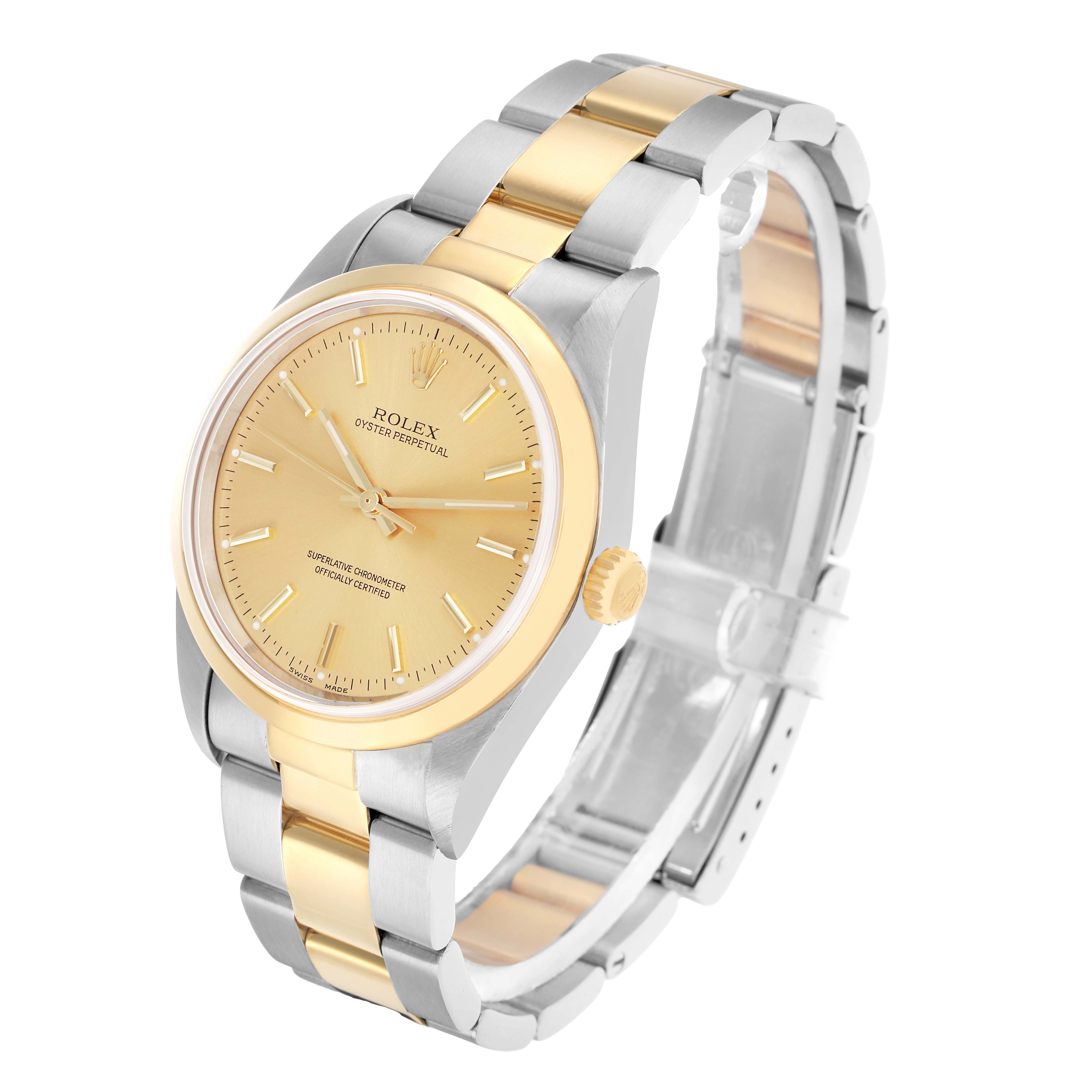 The Rolex Oyster Perpetual 14203 Men
s Steel and Gold (two tone) Champagne Dial watch is shown in a three-quarter view, highlighting the gold and silver bracelet, bezel, and dial.