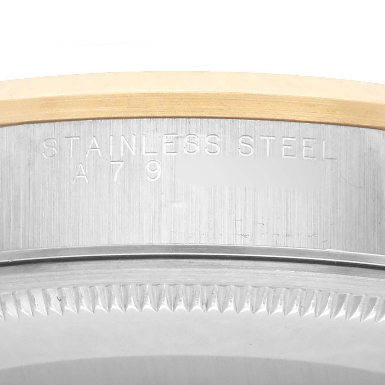 The image shows a close-up of the Oyster Perpetual Rolex watch bezel and case side, highlighting the stainless steel and engraving.