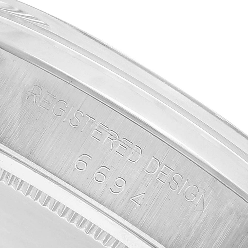 This image shows an extreme close-up angle of the case side of the Vintage Collection model by Rolex, focusing on the engraved text "REGISTERED DESIGN 6694."