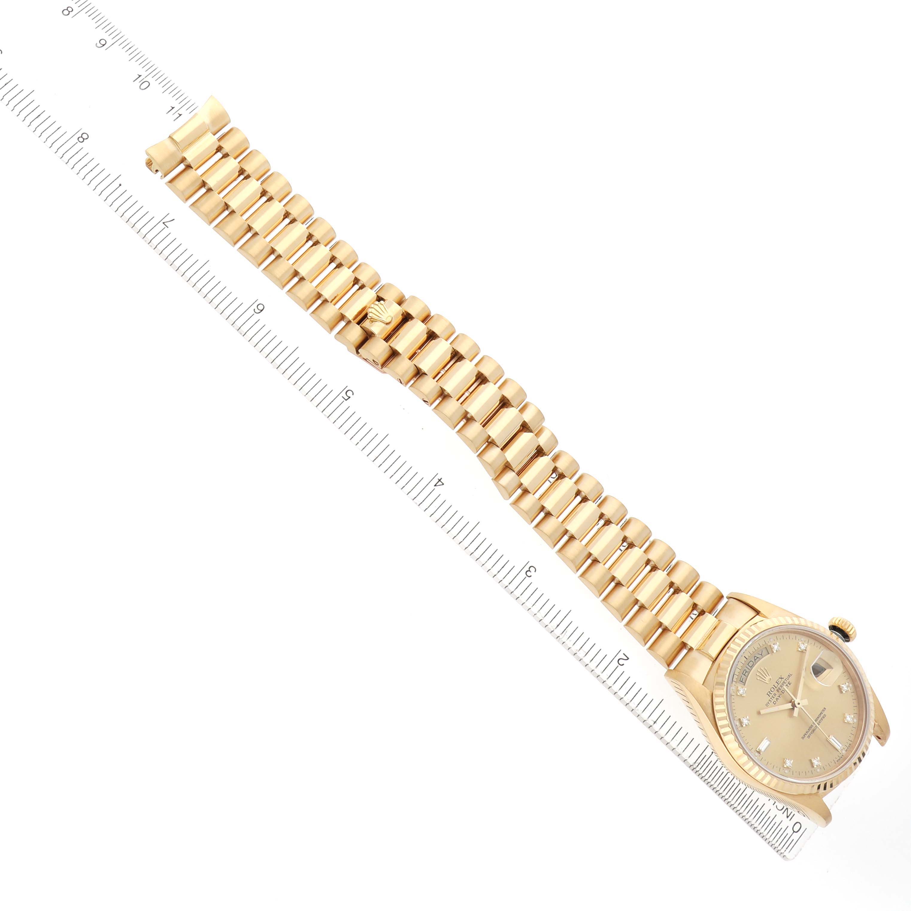 The Rolex President 18038 Men
s Yellow Gold Champagne Dial model watch is shown from a top view, highlighting its gold bracelet and case alongside a measuring ruler.