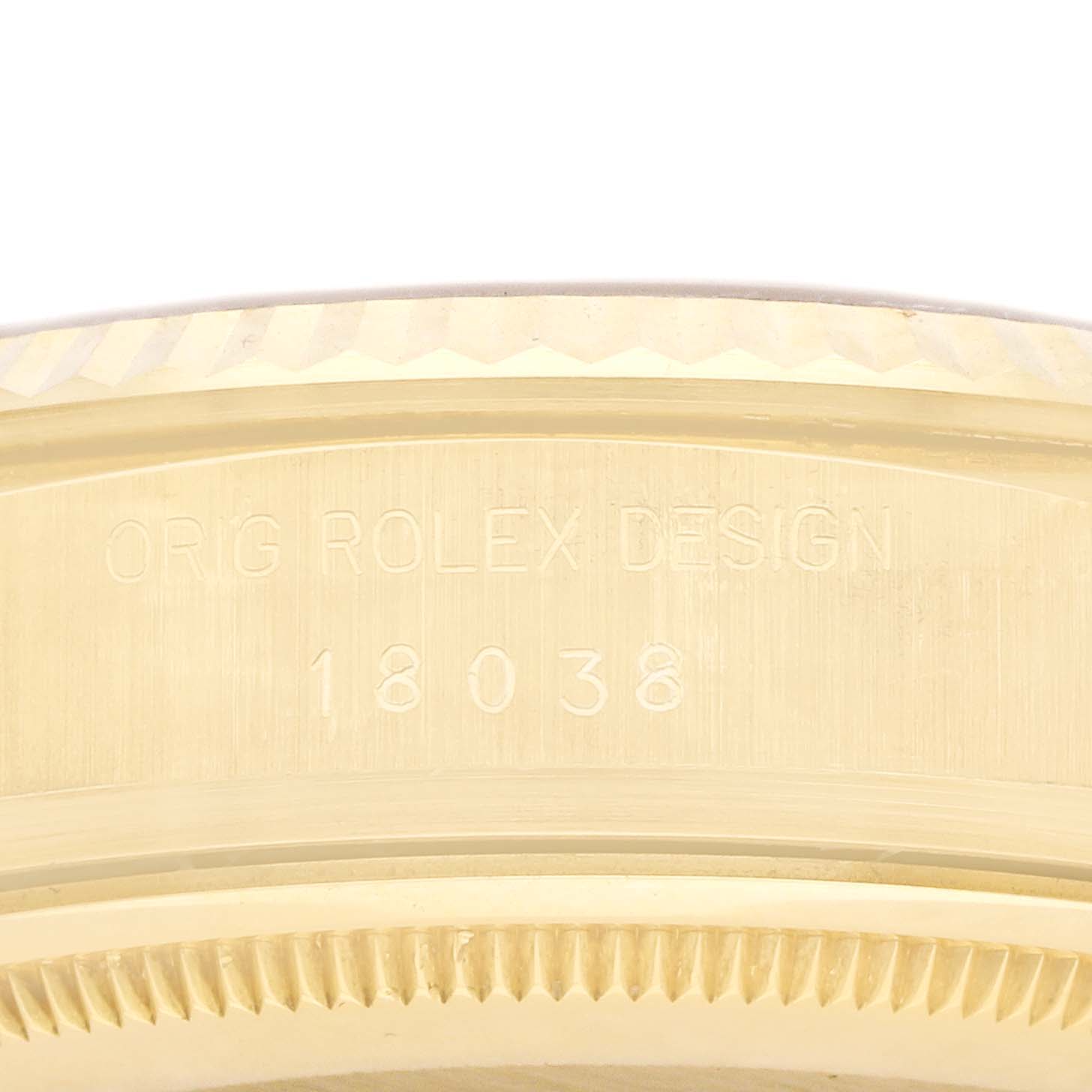 The image shows a close-up of a Rolex President 18038 Men
s Yellow Gold Champagne Dial watch
s case side, featuring the engraved model number "18038".