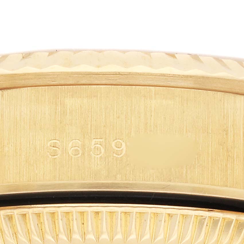 The image shows a close-up of the Rolex President 67198 Women's Yellow Gold Champagne Dial 67198 Women's Yellow Gold Champagne Dial watch's side, highlighting the bezel and serial number.