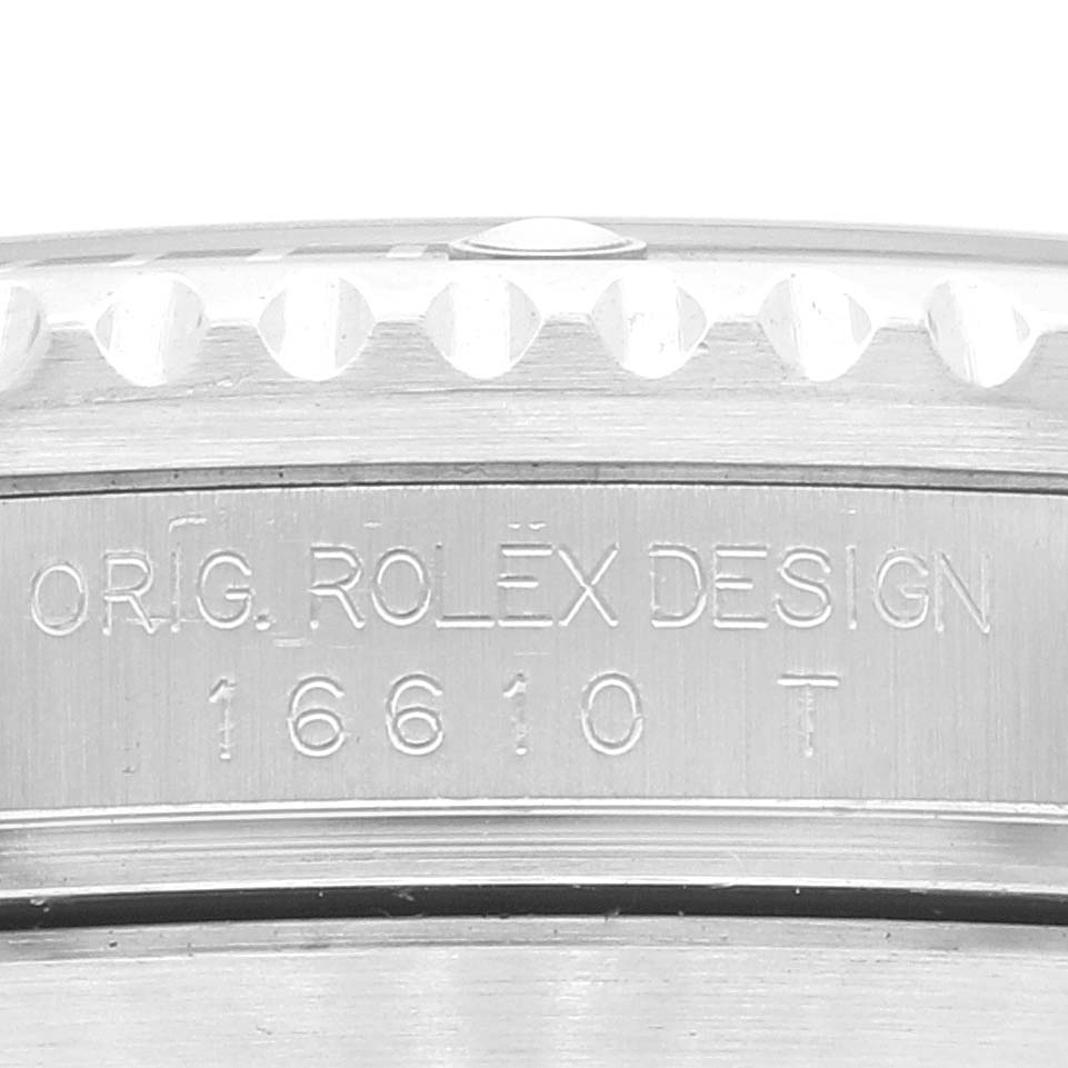 This image shows a close-up view of the engraving on the side of the bezel and case of a Rolex Submariner 16610LV Men's Stainless Steel Black Dial 16610LV Men's Stainless Steel Black Dial model 16610.