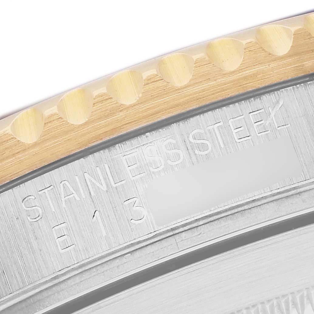 The image shows a partial view of the engraved case back of a Rolex Submariner 16613 Men
s Steel and Gold (two tone) Blue Dial, highlighting the stainless steel material.