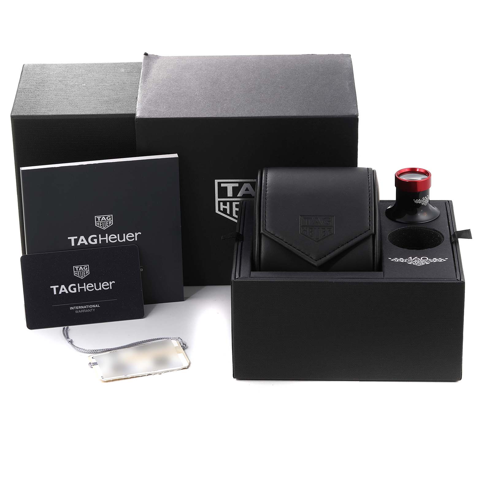 This image shows the packaging, carrying case, loupe, warranty card, and manual for the Tag Heuer Limited Edition CBN2A1D.BA0643 Men's Stainless Steel Silver Dial CBN2A1D.BA0643 Men's Stainless Steel Silver Dial watch.