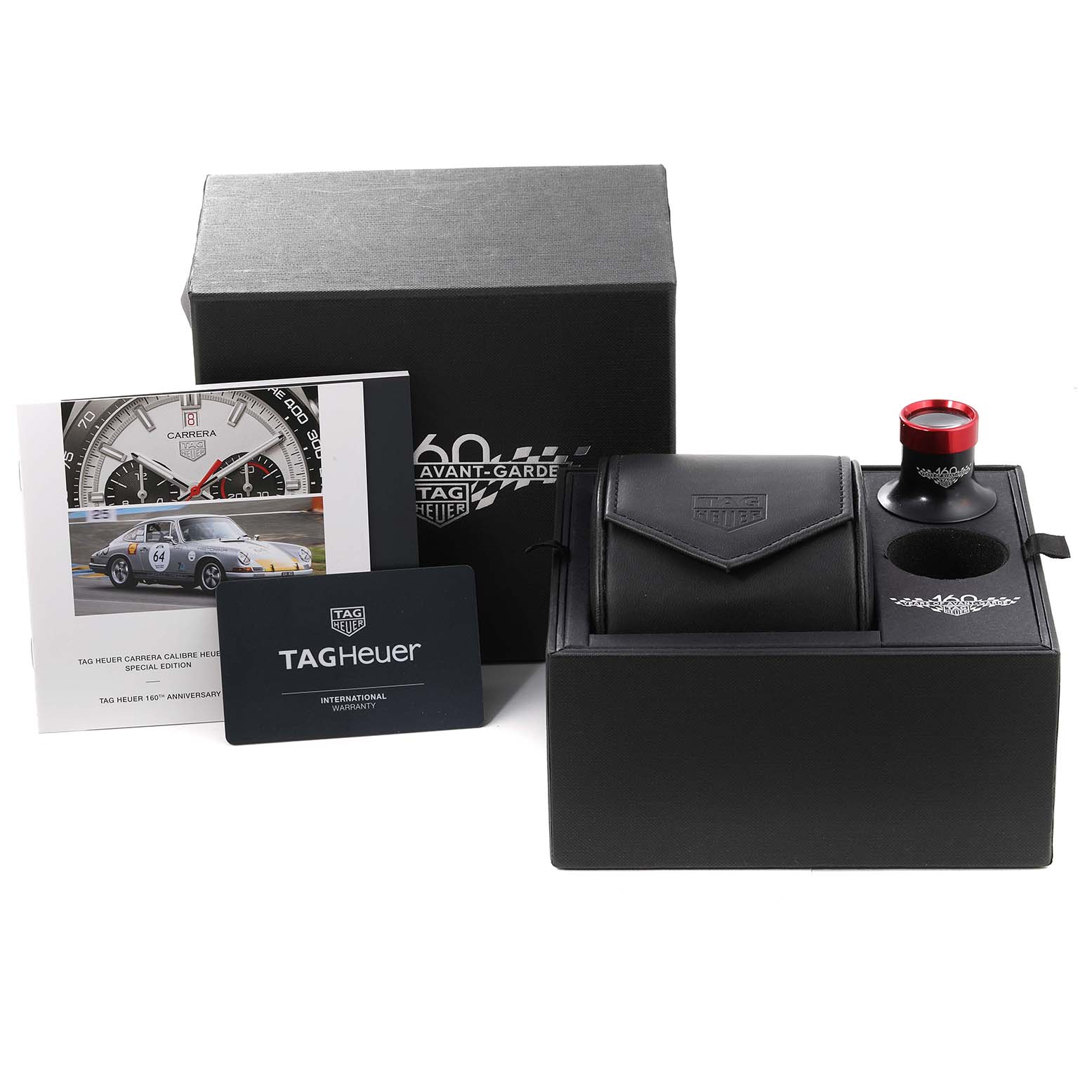 The image shows a Tag Heuer Limited Edition CBN2A1D.BA0643 Men's Stainless Steel Silver Dial CBN2A1D.BA0643 Men's Stainless Steel Silver Dial watch set with its box, warranty card, booklet, and accessories at an angled view.