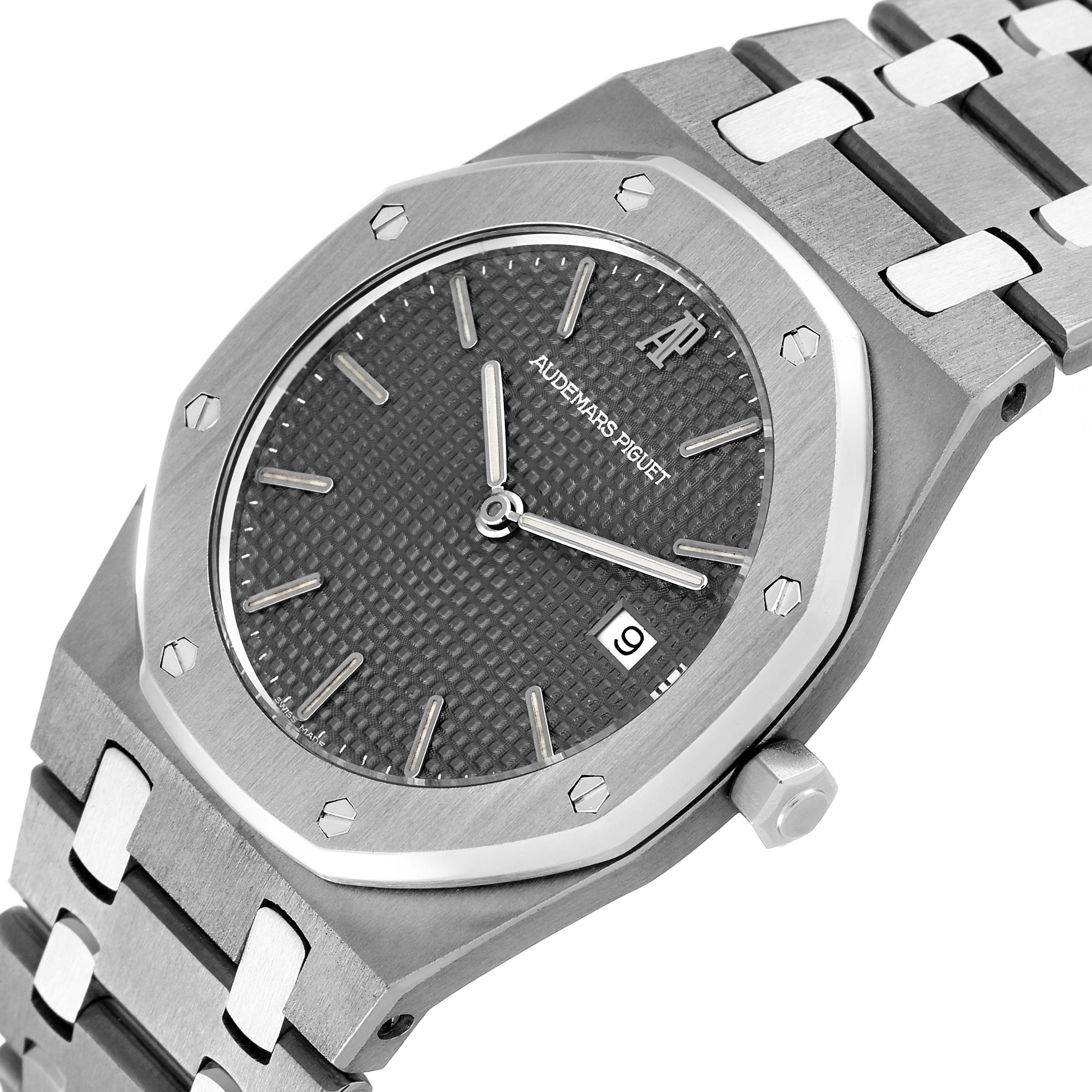 The image shows a close-up of an Audemars Piguet Royal Oak 56175TT Men's Titanium Grey Dial 56175TT Men's Titanium Grey Dial watch, highlighting the dial, case, crown, and part of the bracelet from a slightly tilted angle.