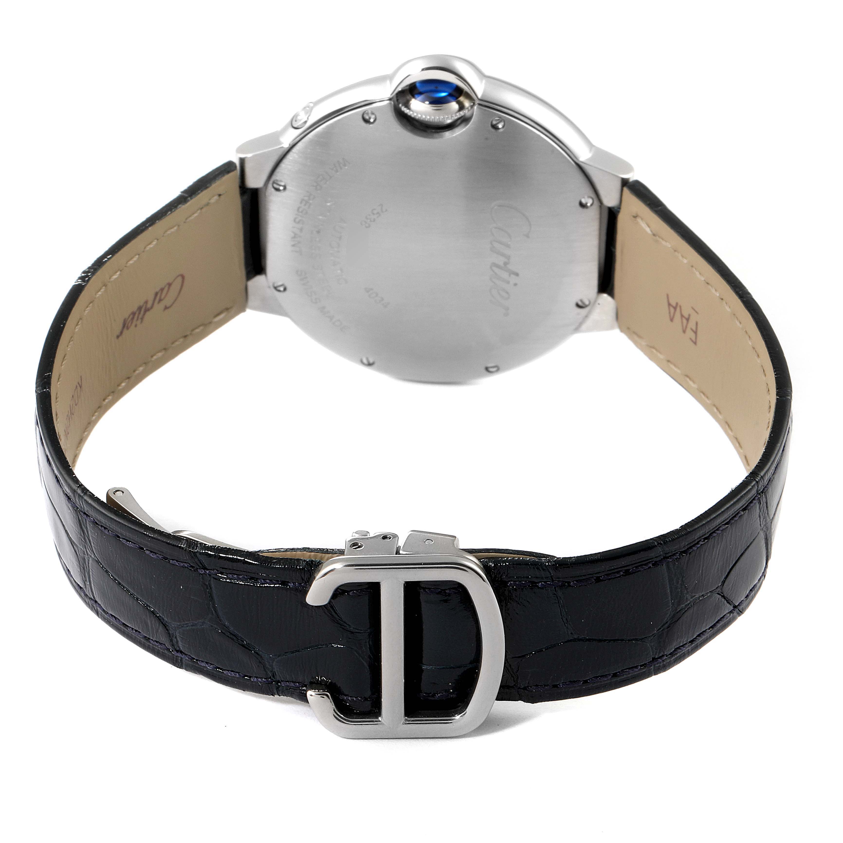 The image shows the back and side of a Ballon Bleu model by Cartier, highlighting the back case, blue cabochon crown, and leather strap with a clasp.