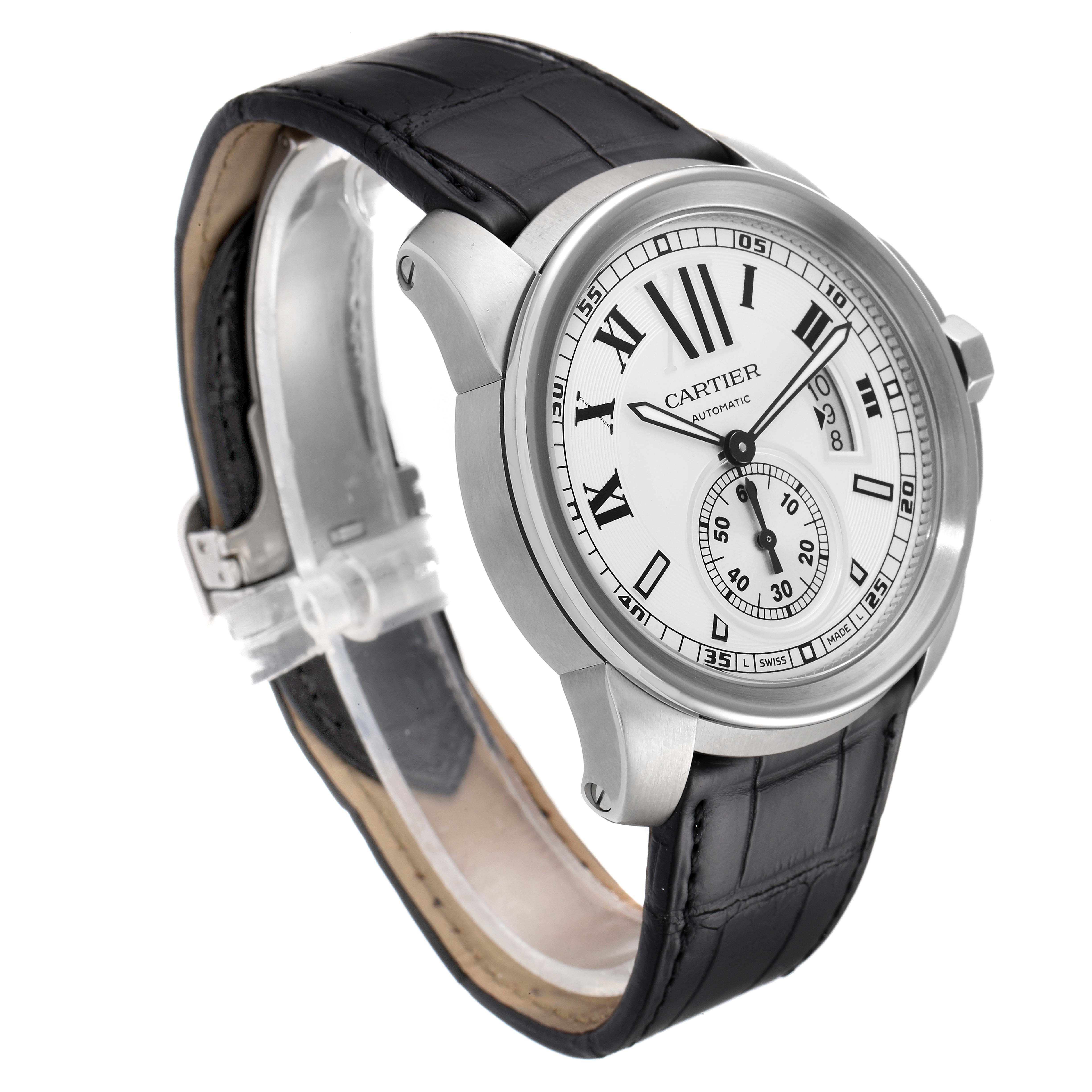 The Calibre de Cartier watch by Cartier is shown at a three-quarter angle, highlighting the face, bezel, and black leather strap.