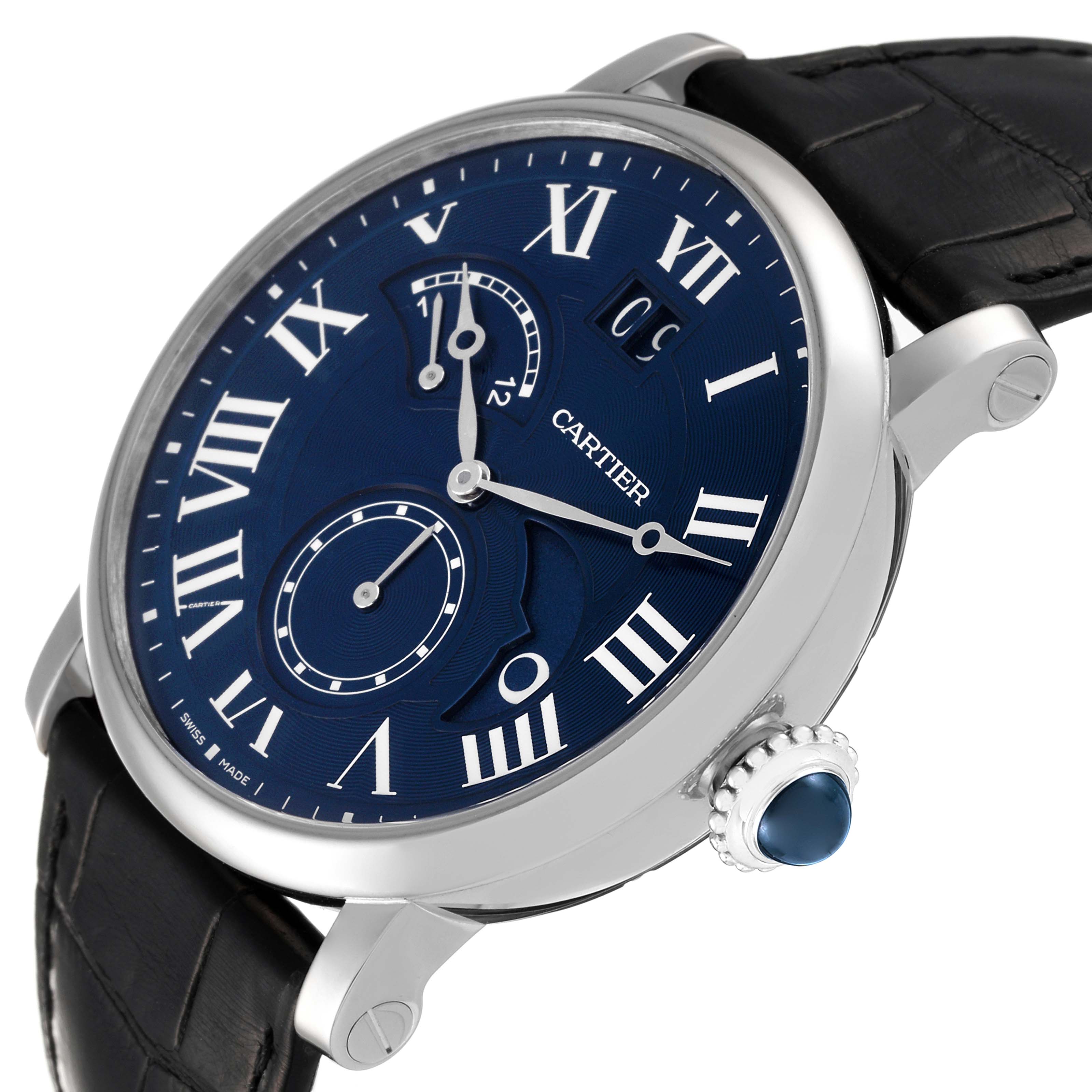 The image shows a close-up angled view of a Rotonde model by Cartier, featuring its blue dial, Roman numerals, and black leather strap.