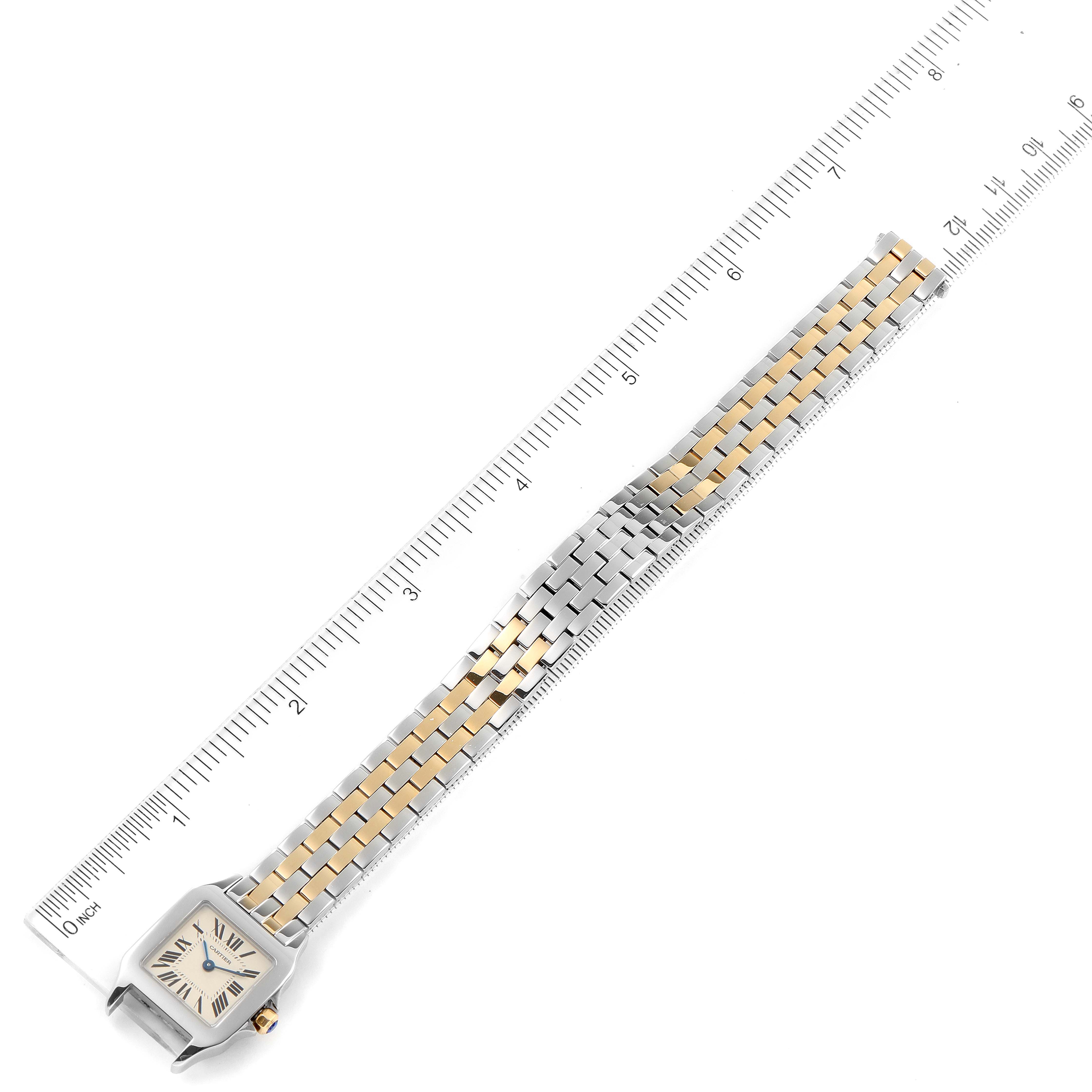 The image shows an overhead view of the Cartier Santos Demoiselle W25066Z6 Women's Steel and Gold (two tone) Silver Dial W25066Z6 Women's Steel and Gold (two tone) Silver Dial watch, highlighting the face and entire length of the two-tone bracelet.